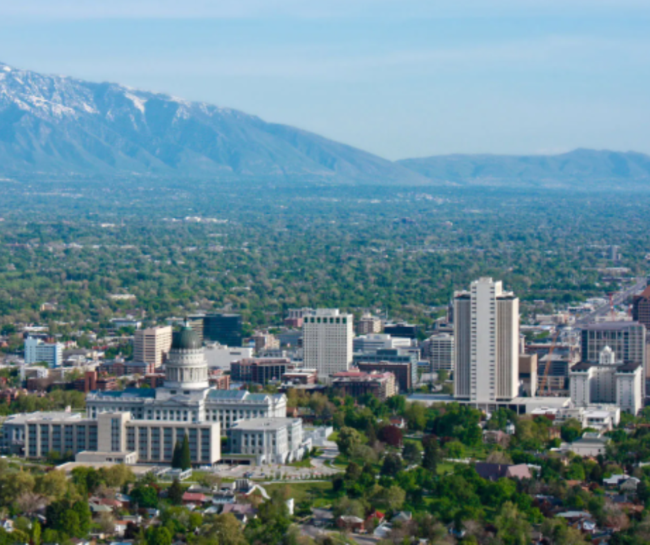 A city skyline with a statue in the foreground