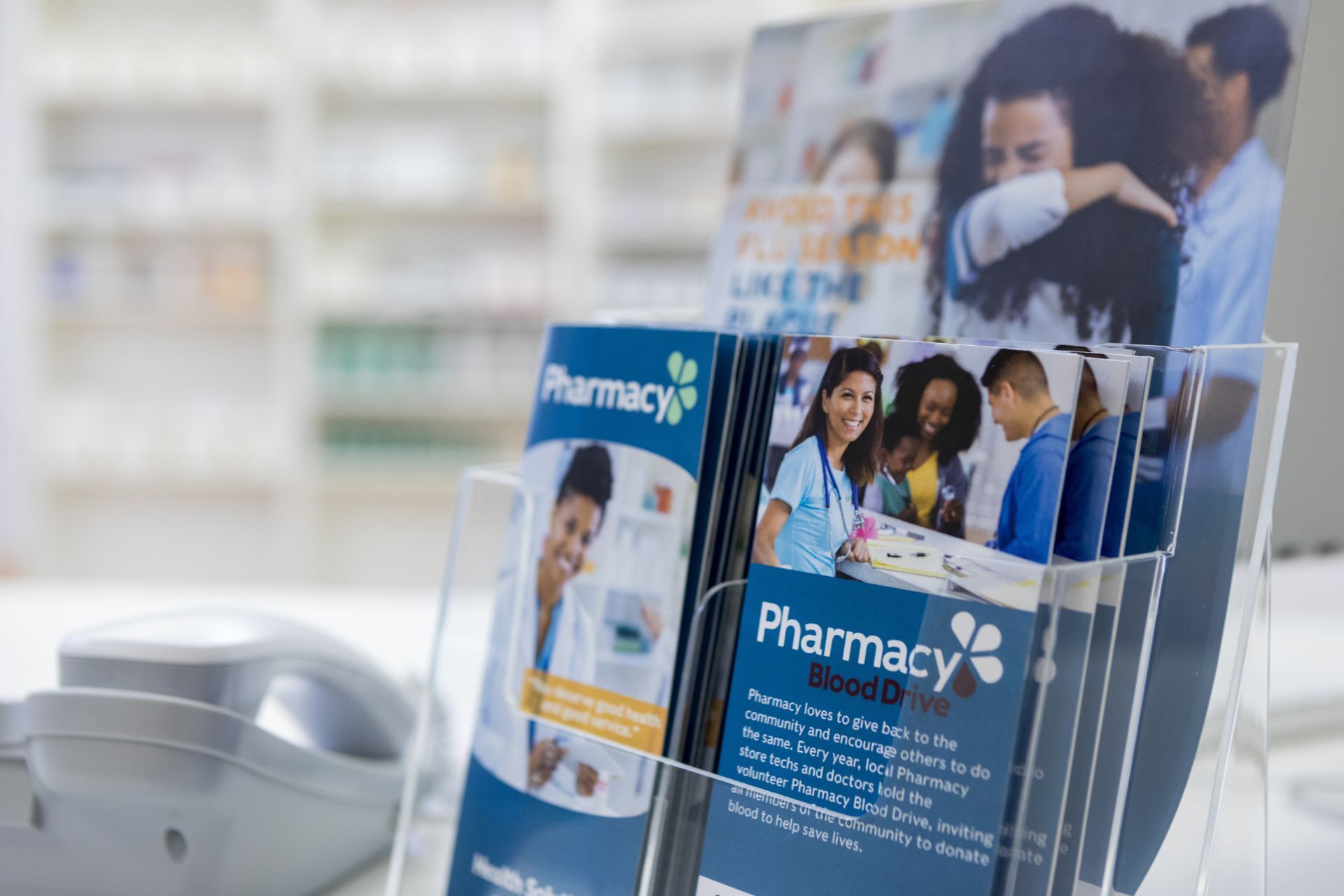 A display of pamphlets in a pharmacy on a table.