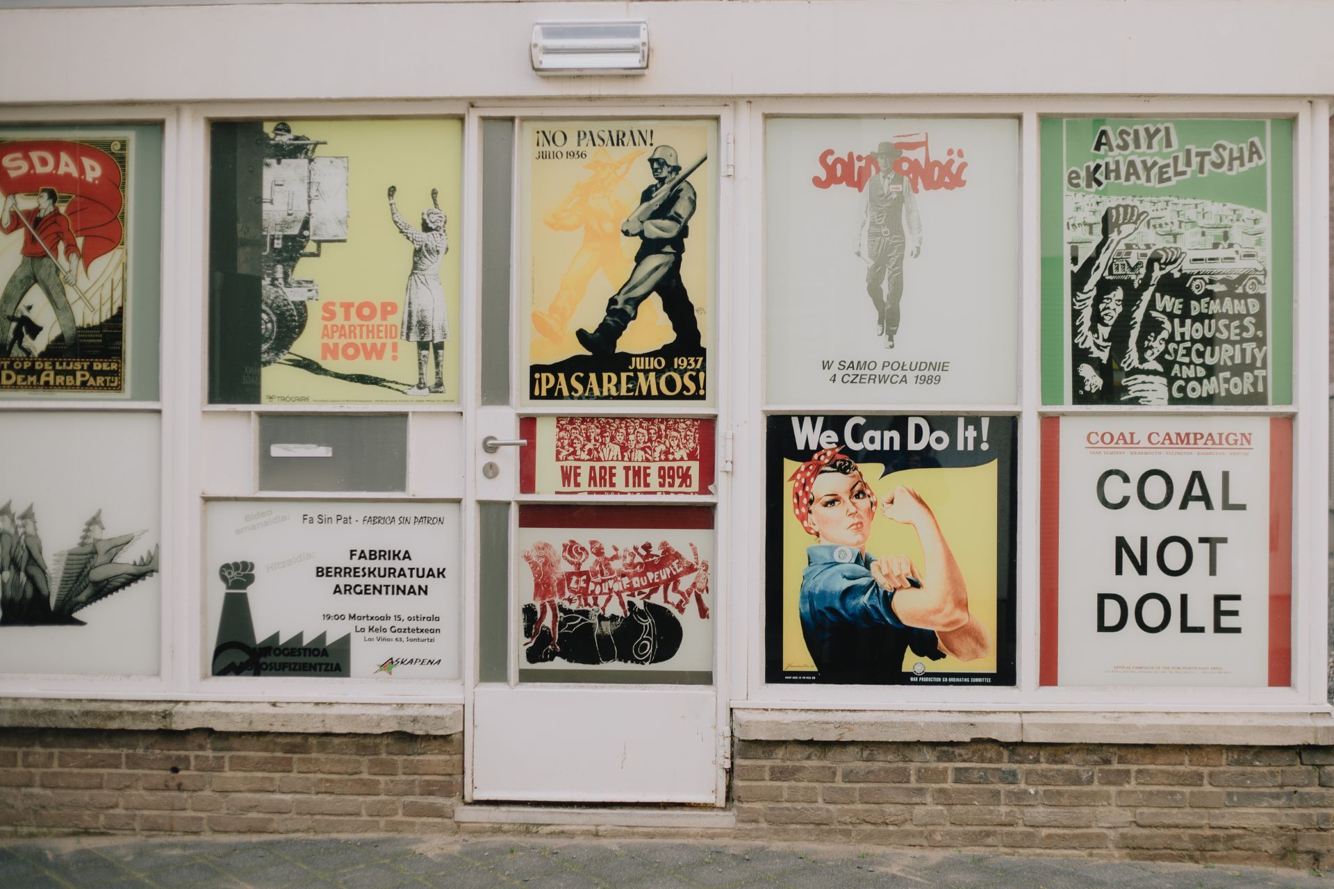 A building with a lot of posters on it and a sign that says coal not dole