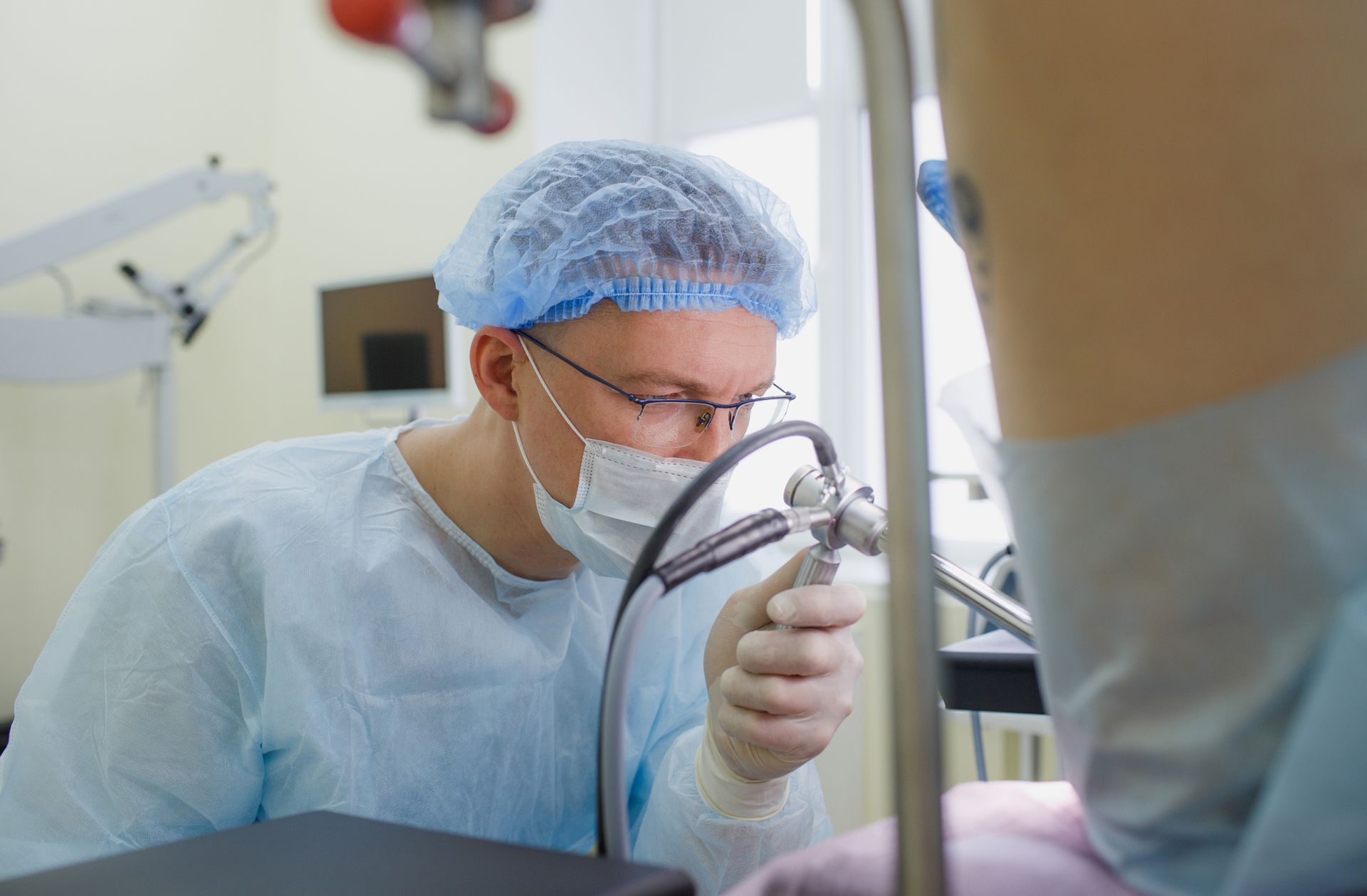 Rectal exam in progress as proctologist assesses patient on medical chair in clinic