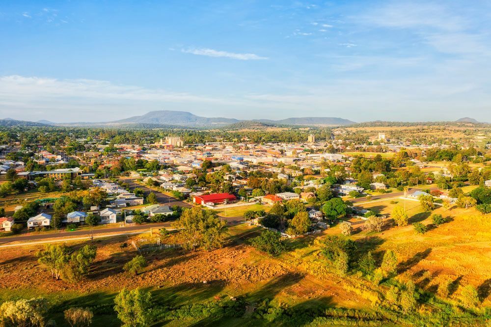 An Aerial View of a Small Town Surrounded by Trees and Mountains — Shane’s Car Detailing & Office Cleaning in Gunnedah, NSW