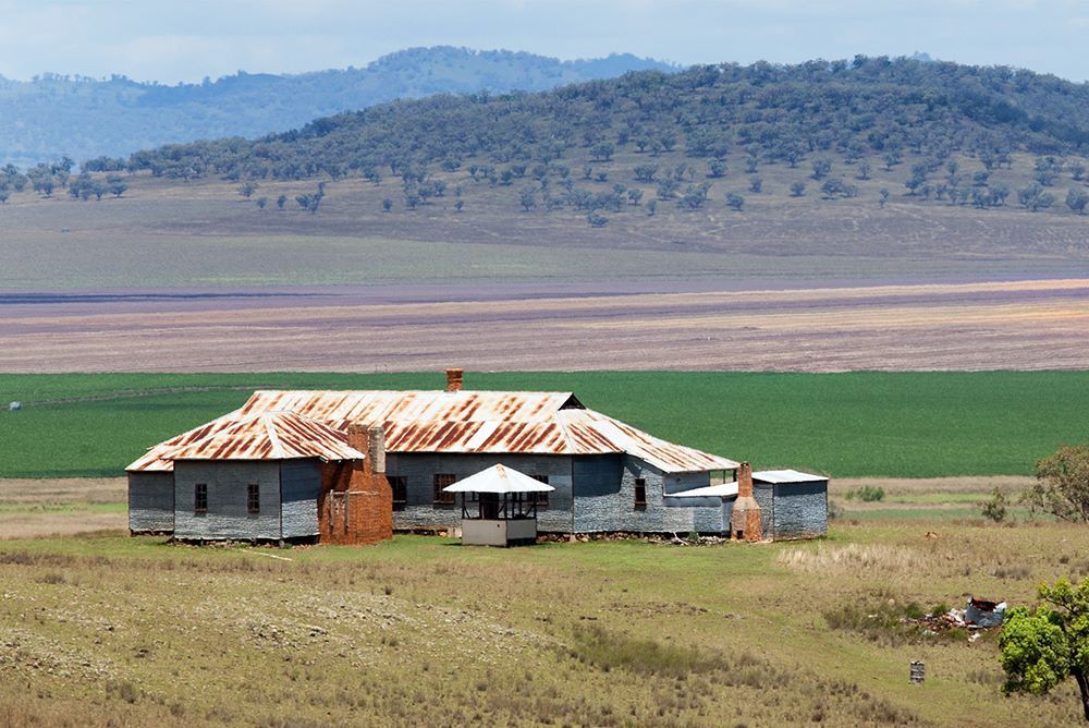An Old House in the Middle of a Field With Mountains in the Background — Shane’s Car Detailing & Office Cleaning in Quirindi, NSW
