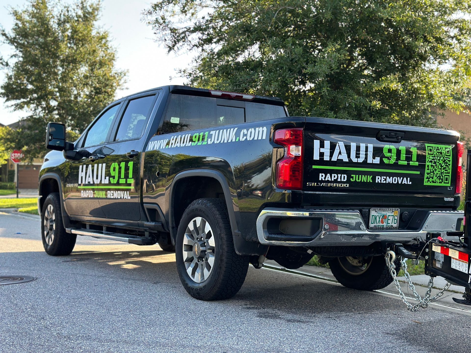 A black pickup truck parked on a street with 