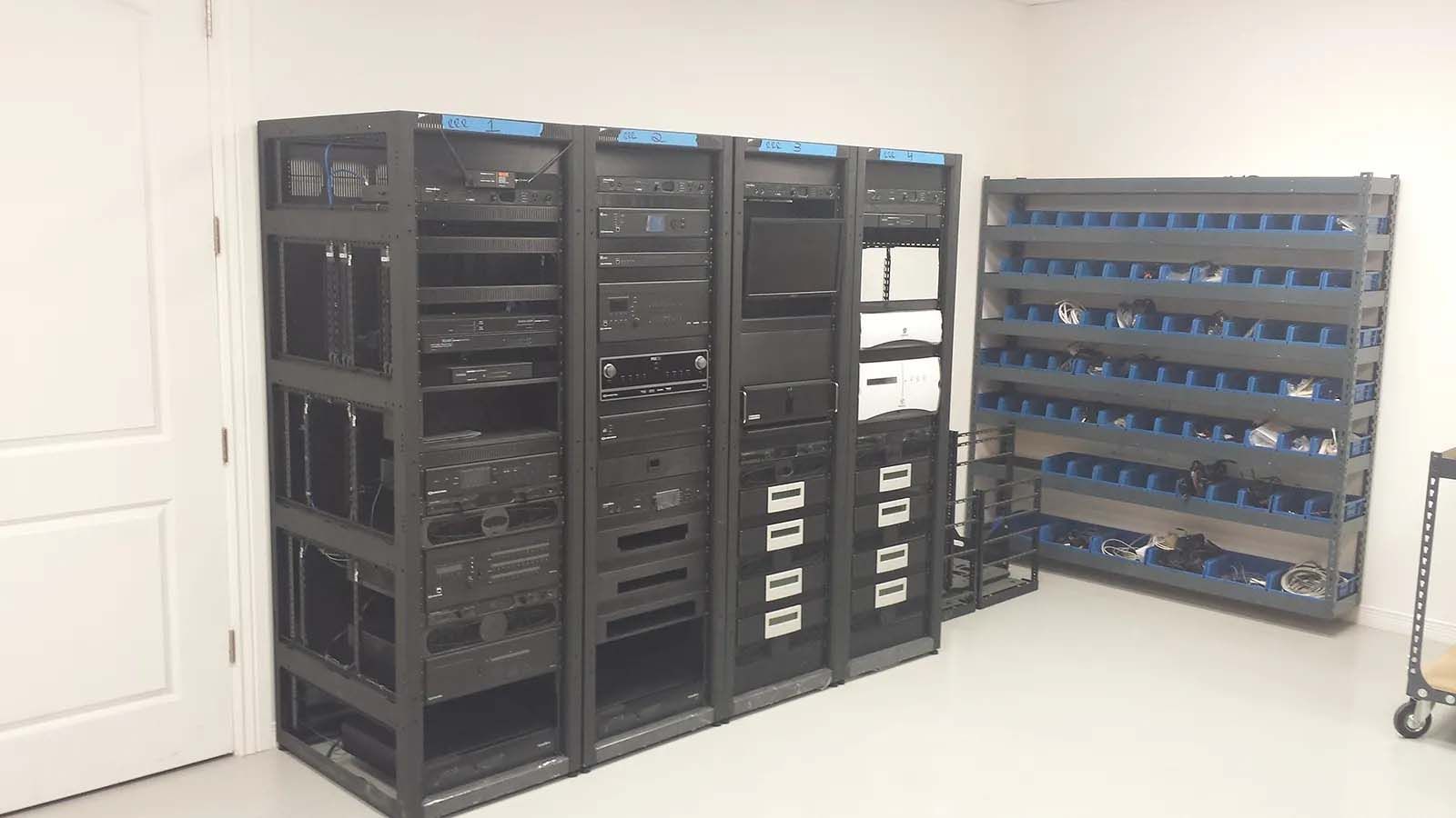 A room filled with lots of server racks and shelves.