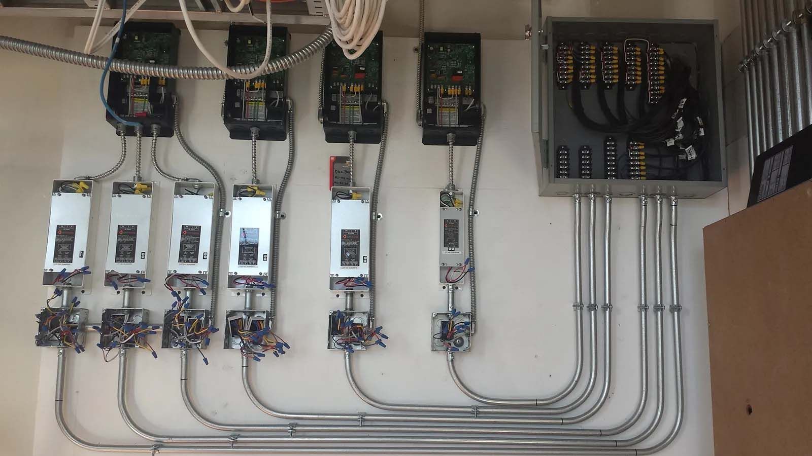 A bunch of electrical equipment is hanging on a wall.