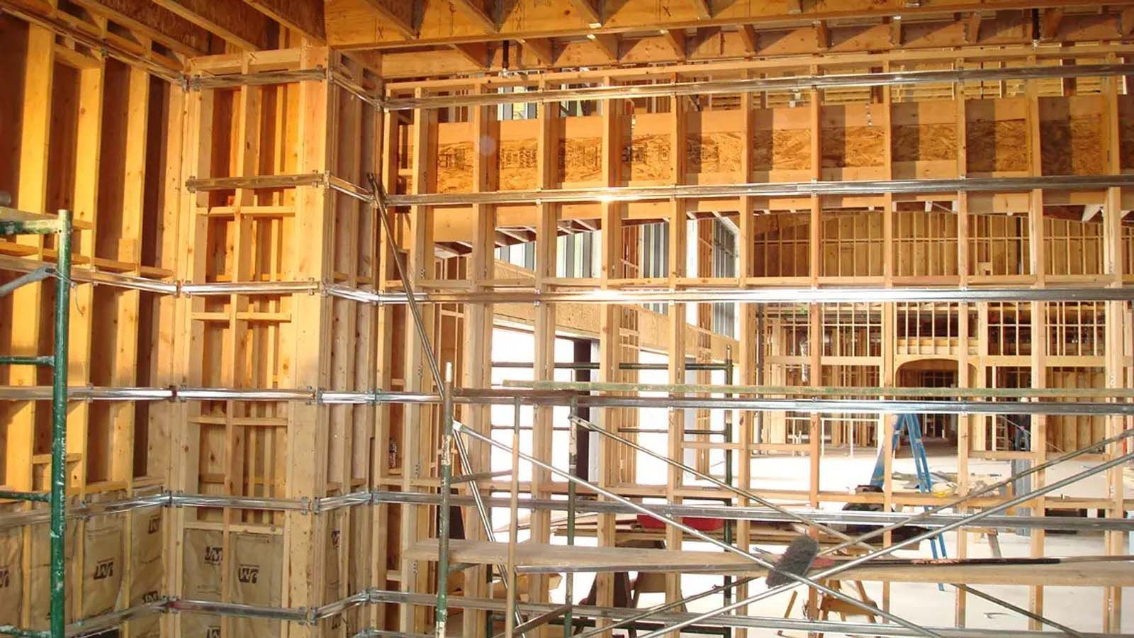 A building under construction with a lot of wooden beams