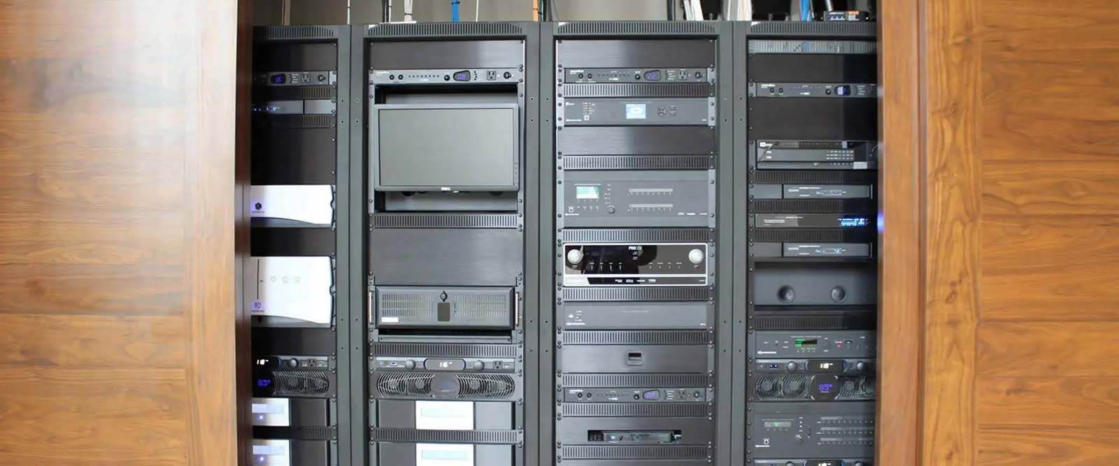 A server room with a lot of servers and monitors