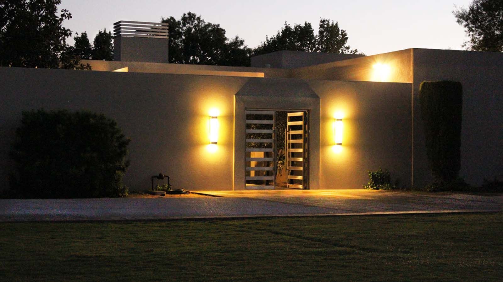The front of a house is lit up at night