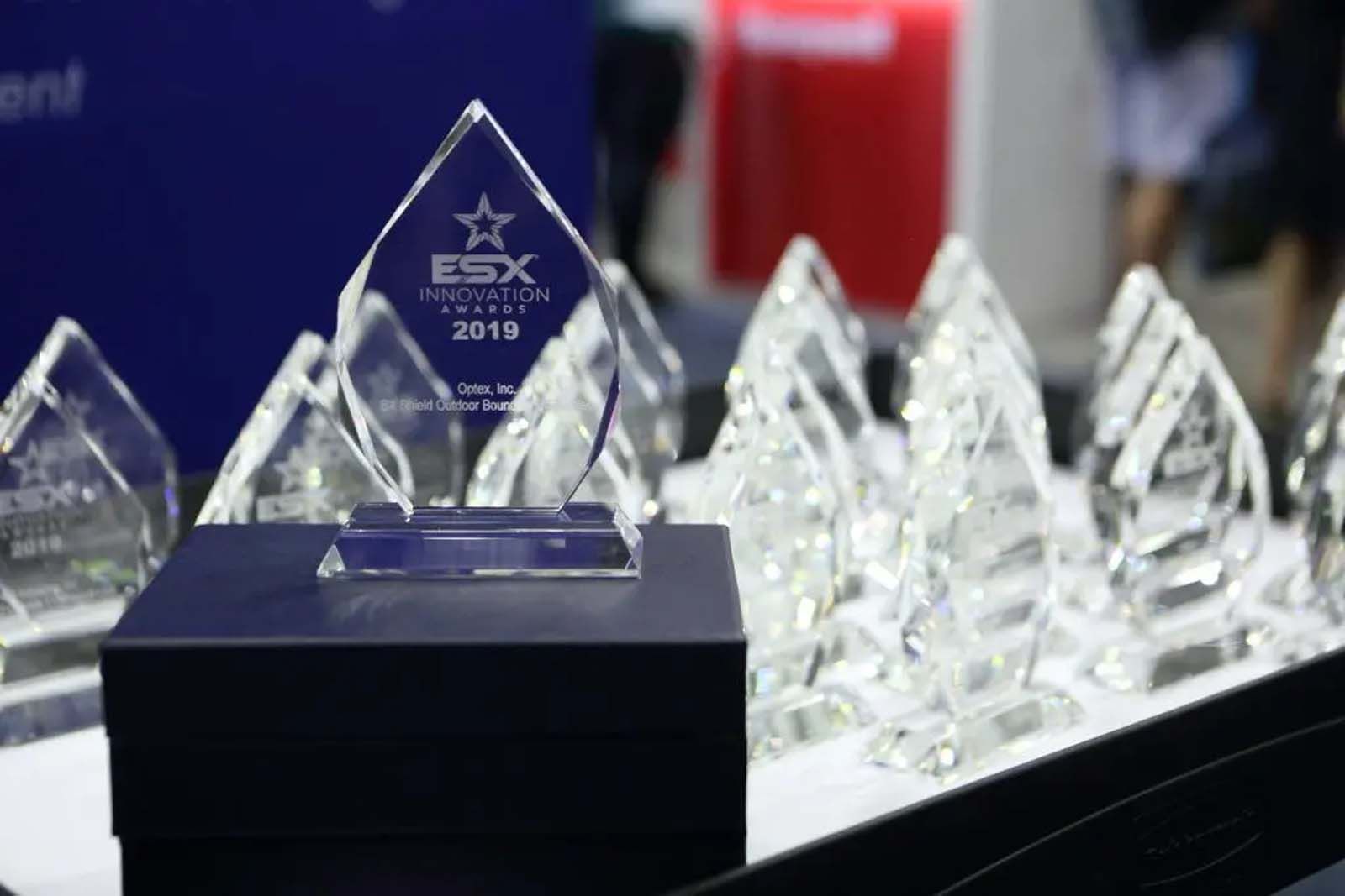 A glass trophy with a star on it is sitting on top of a table.