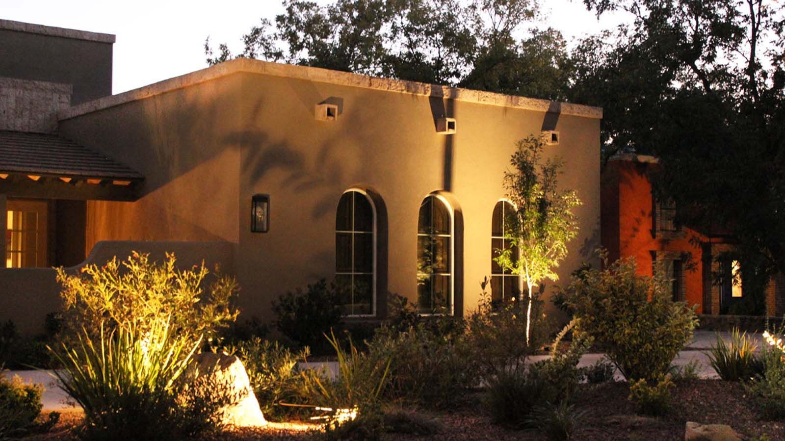 A building with arched windows is lit up at night