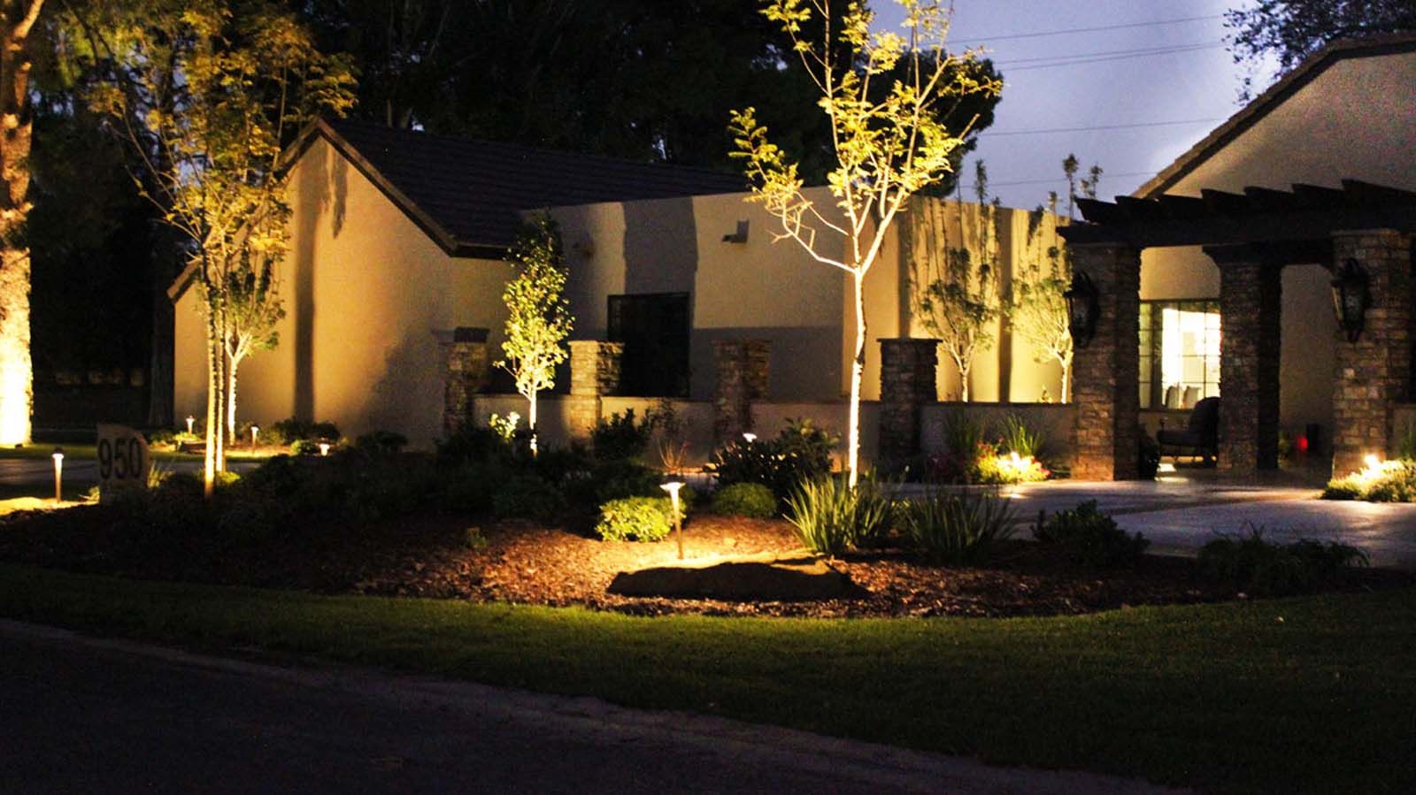 The front of a house is lit up at night