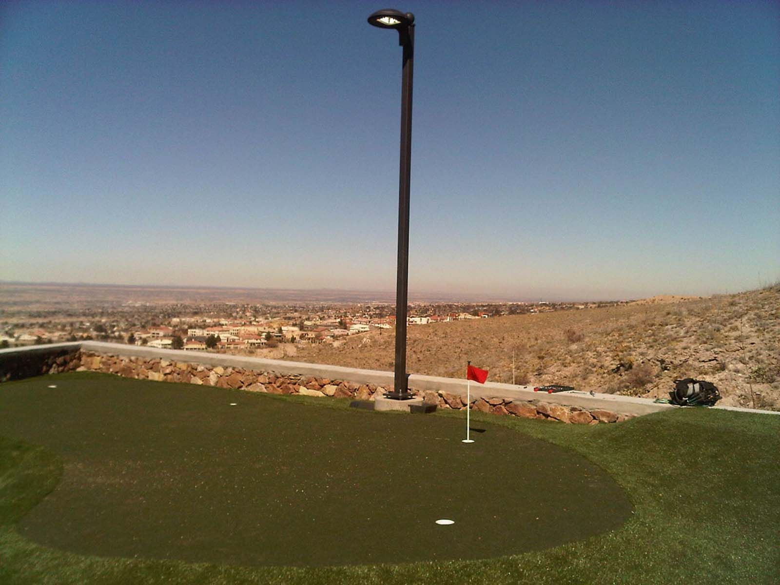 A golf course with a red flag on the green