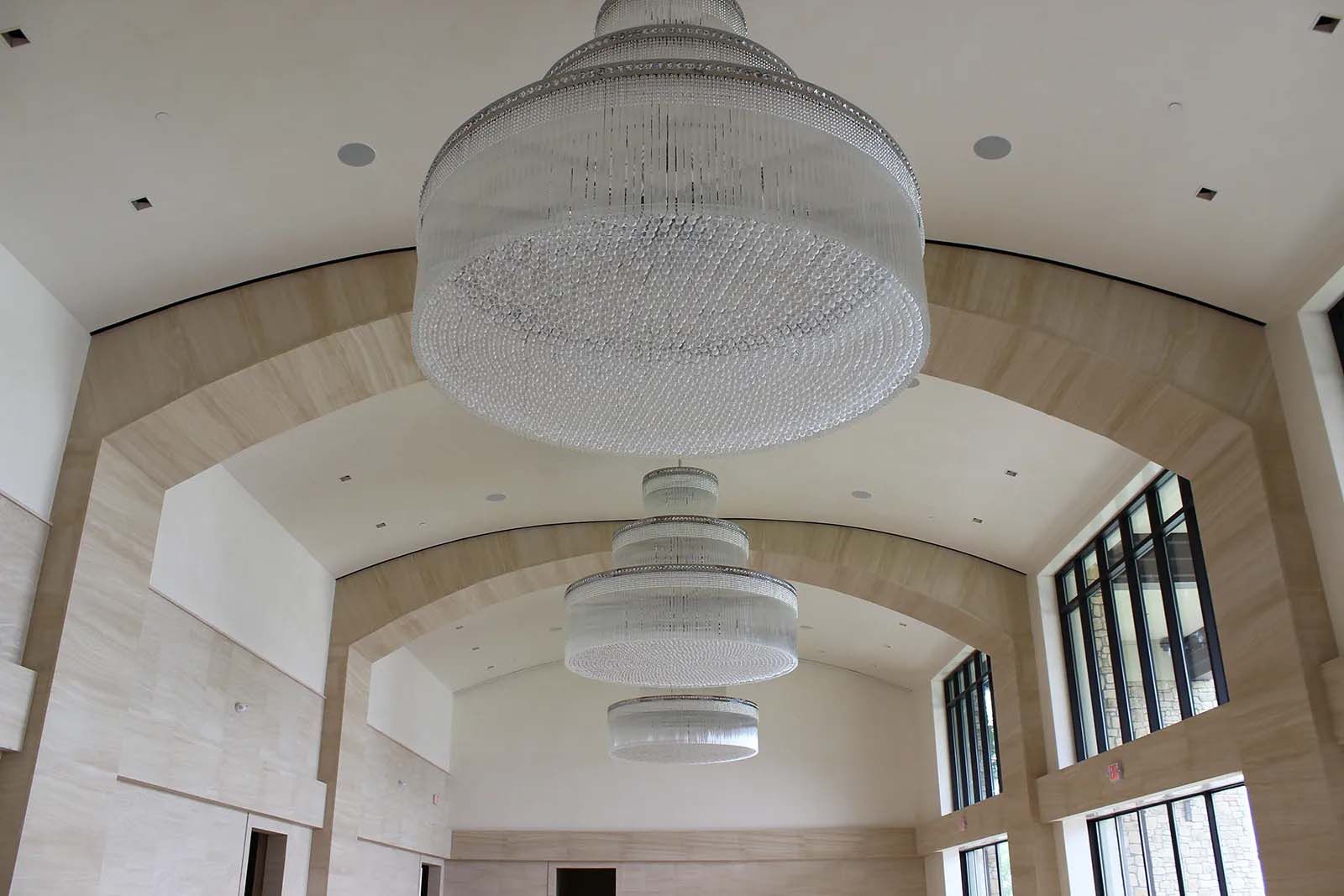 A large chandelier is hanging from the ceiling of a building
