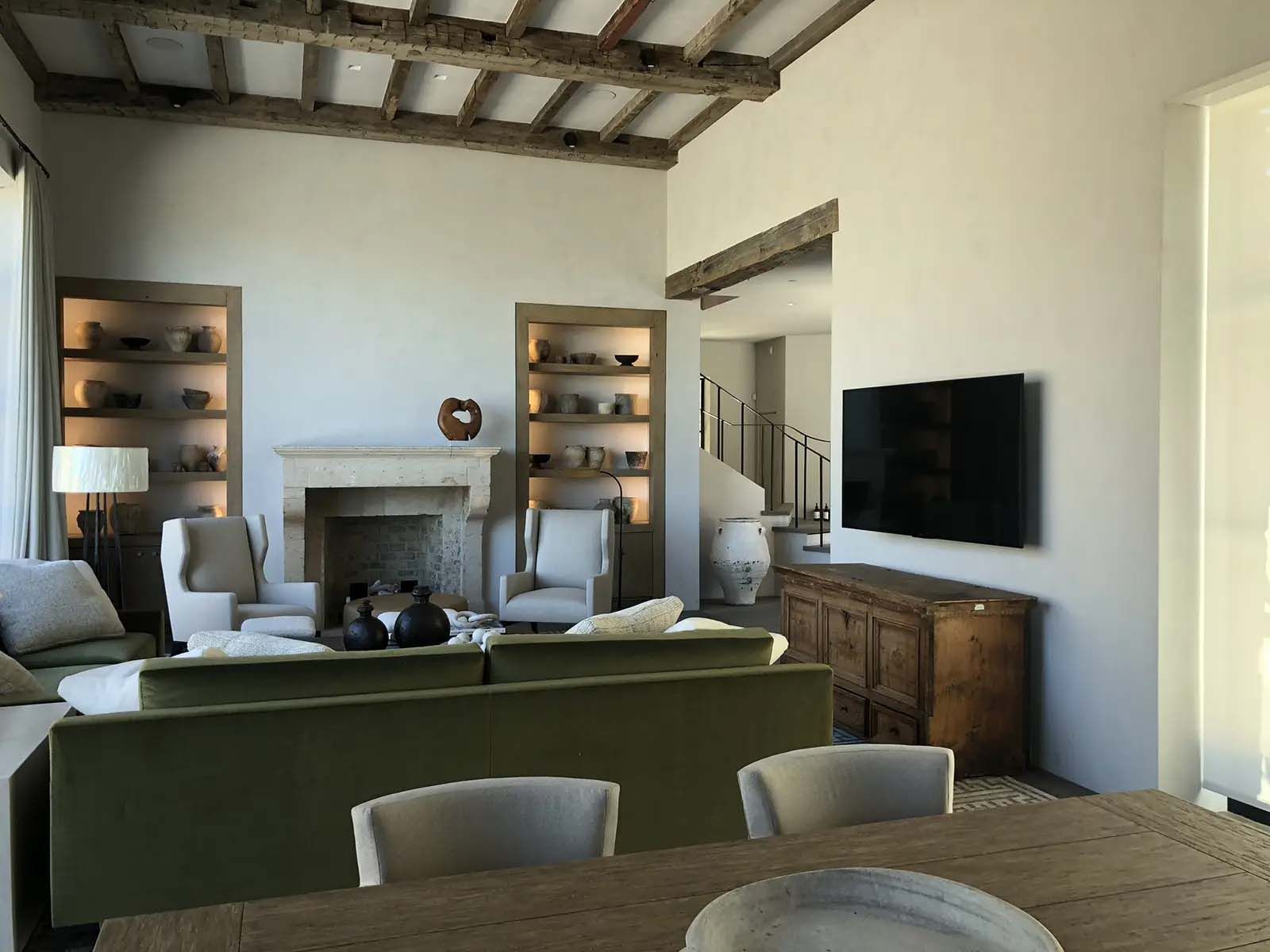 A living room with a fireplace and a flat screen tv