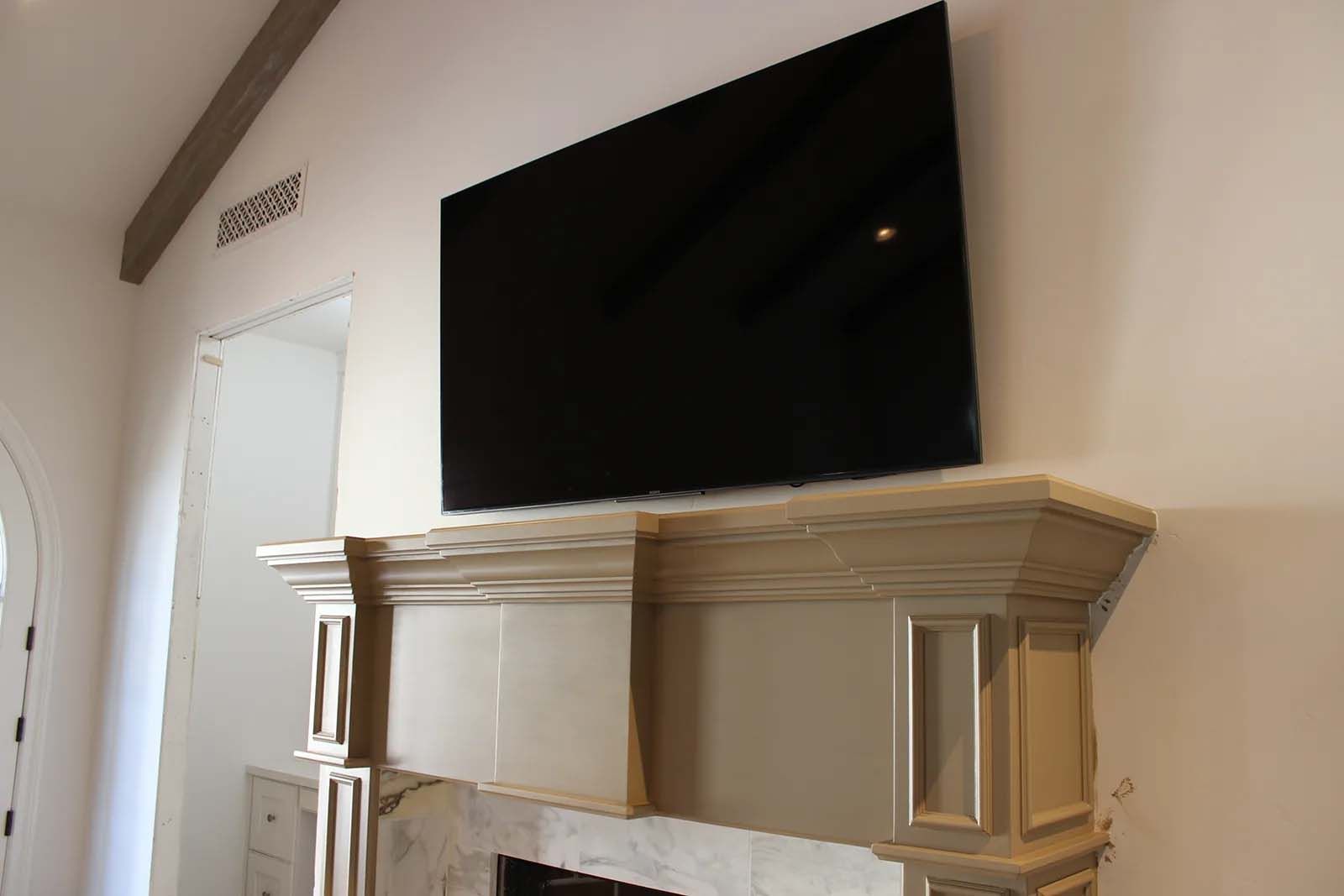 A fireplace with a flat screen tv mounted on the wall above it.