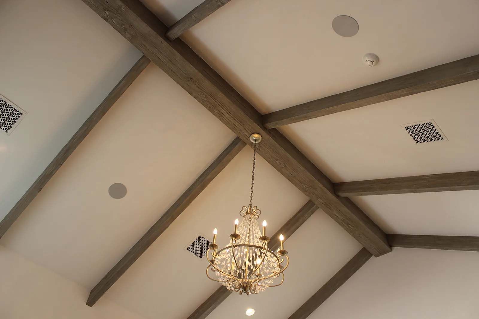 A chandelier is hanging from the ceiling of a room