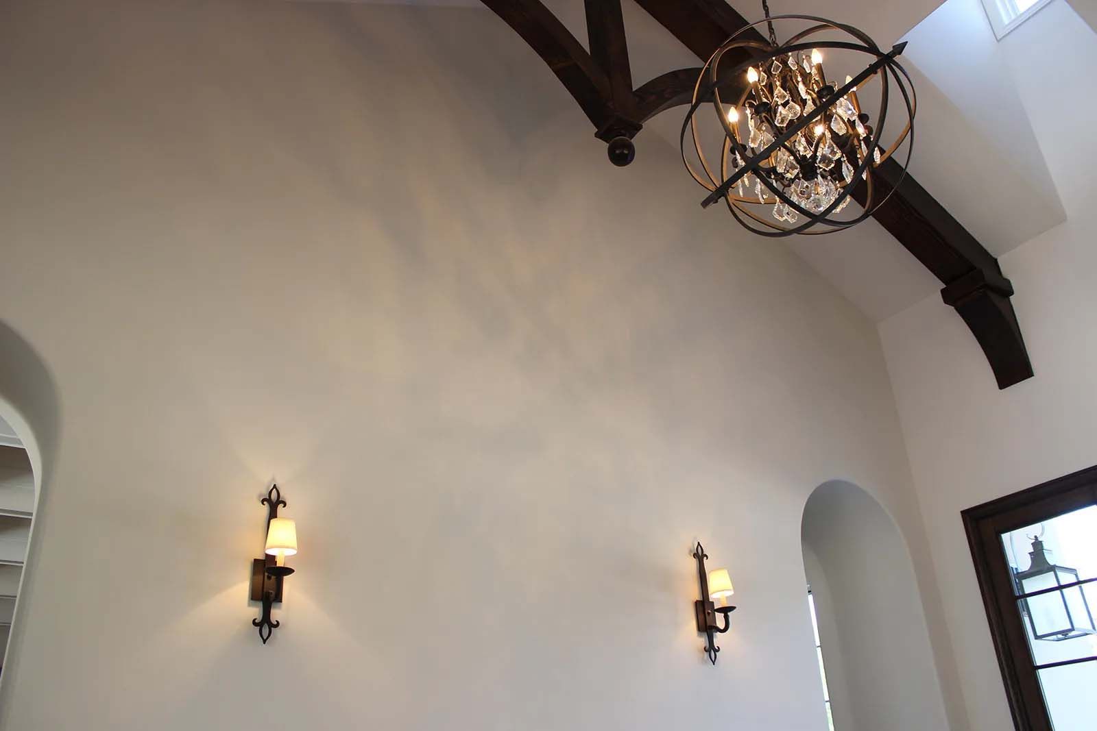 A ceiling with a chandelier hanging from it