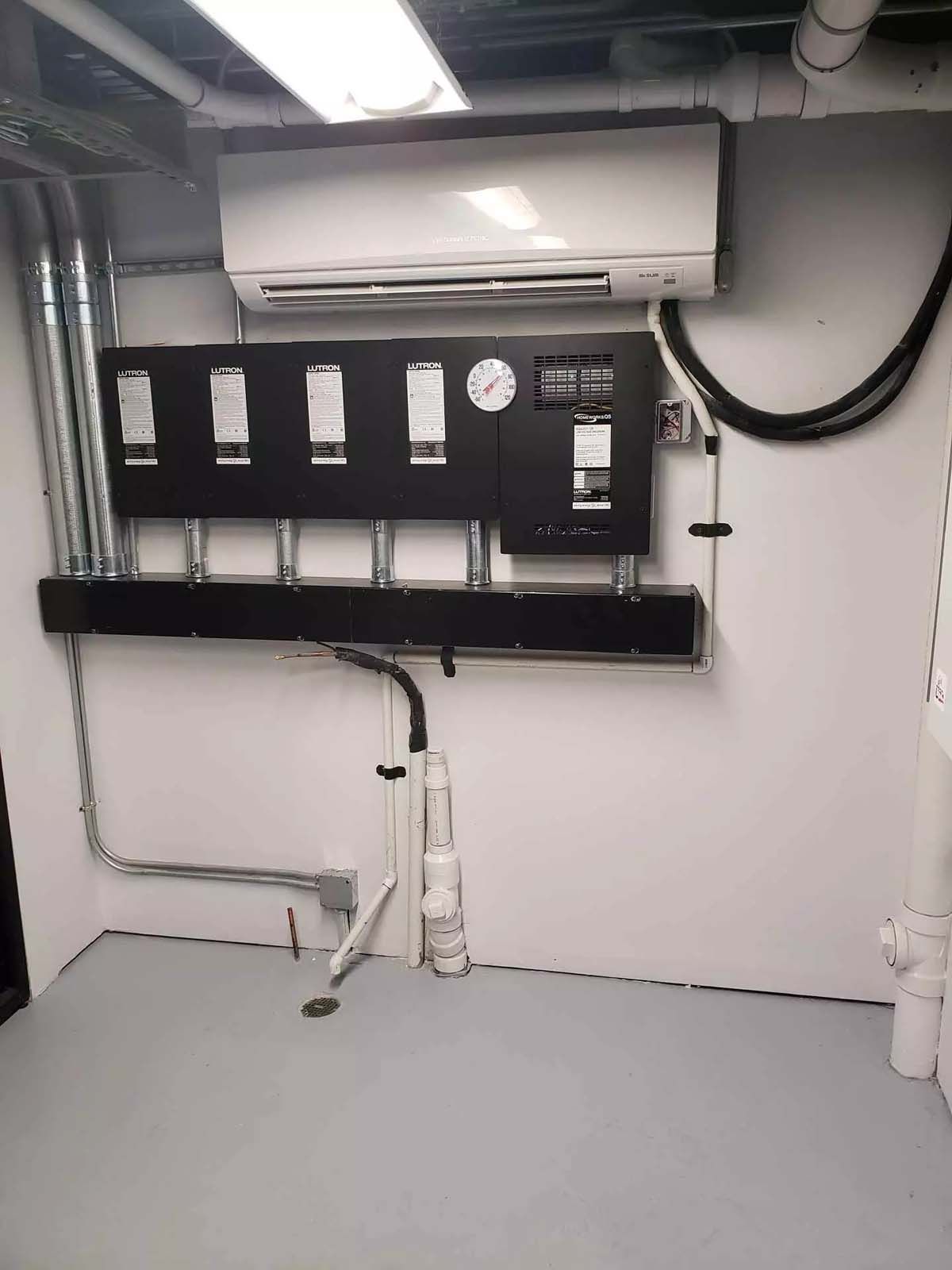 A room with a wall mounted air conditioner and a clock on it.