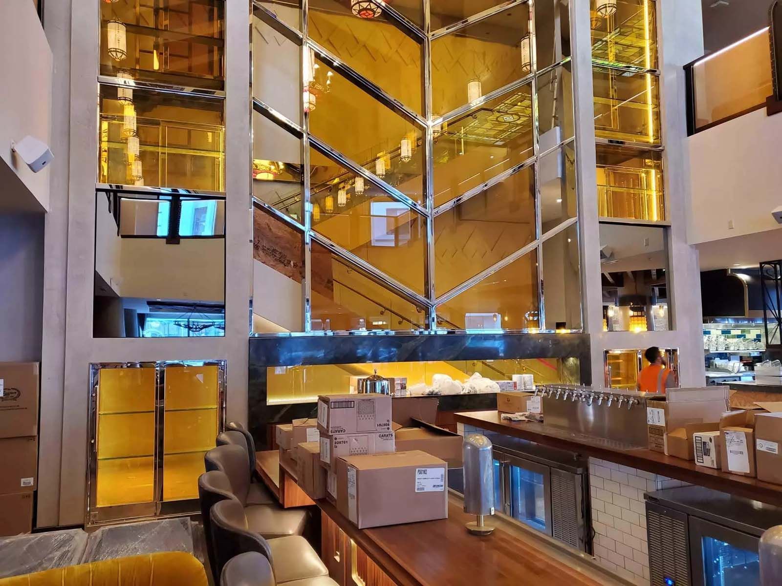 Boxes are stacked on a counter in a large building