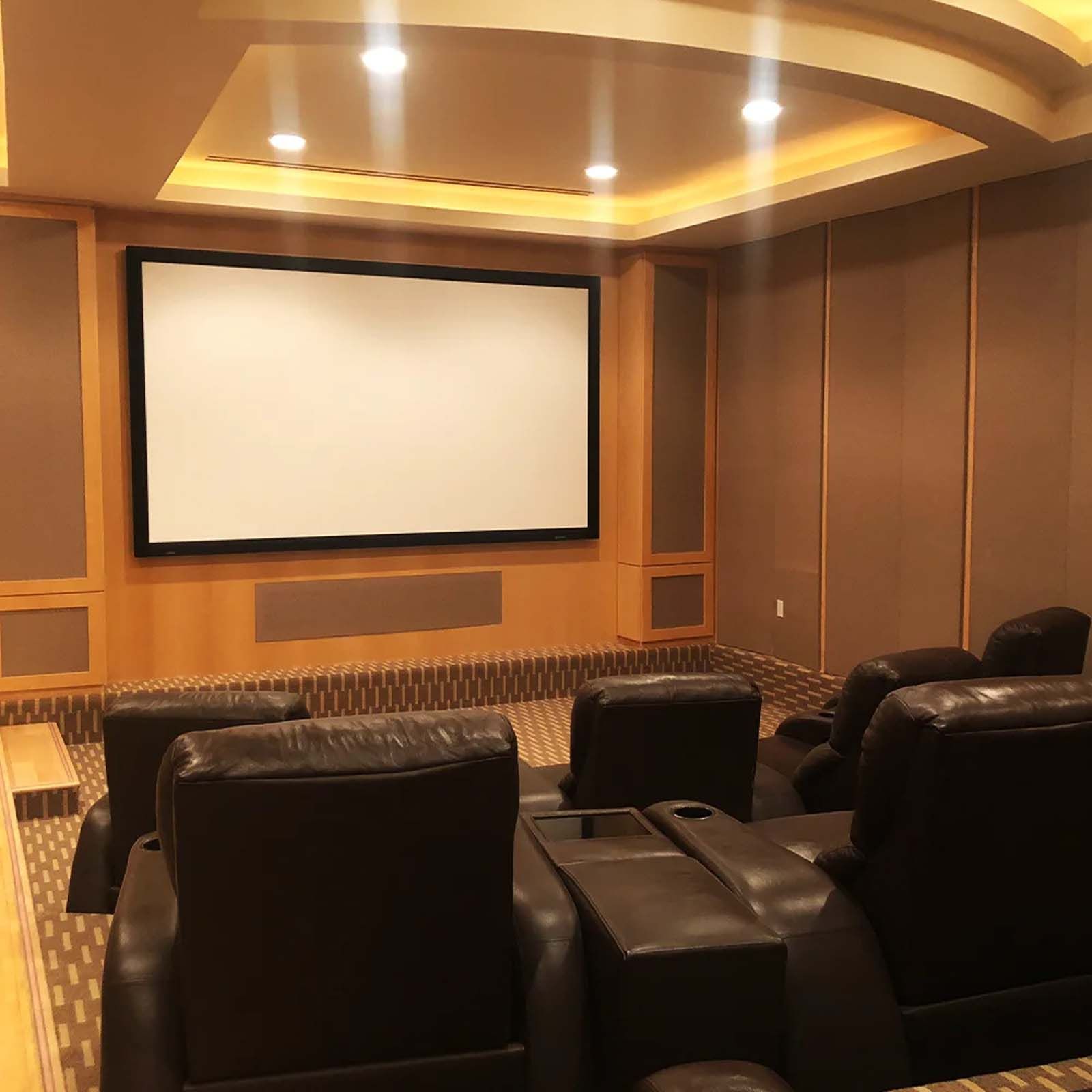 A home theater with a large screen and chairs