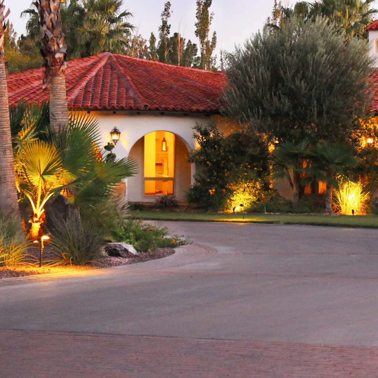 A house with a red tile roof is lit up at night