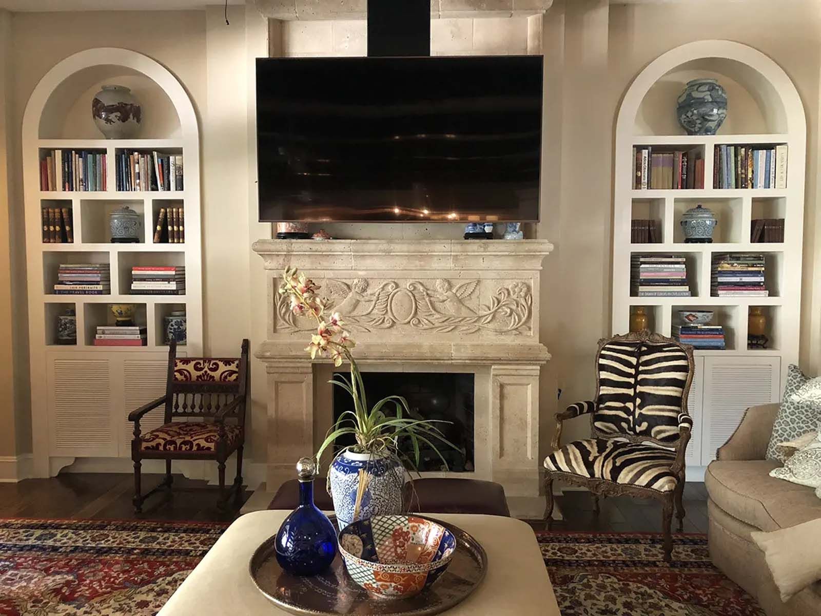 A living room with a fireplace and a flat screen tv.