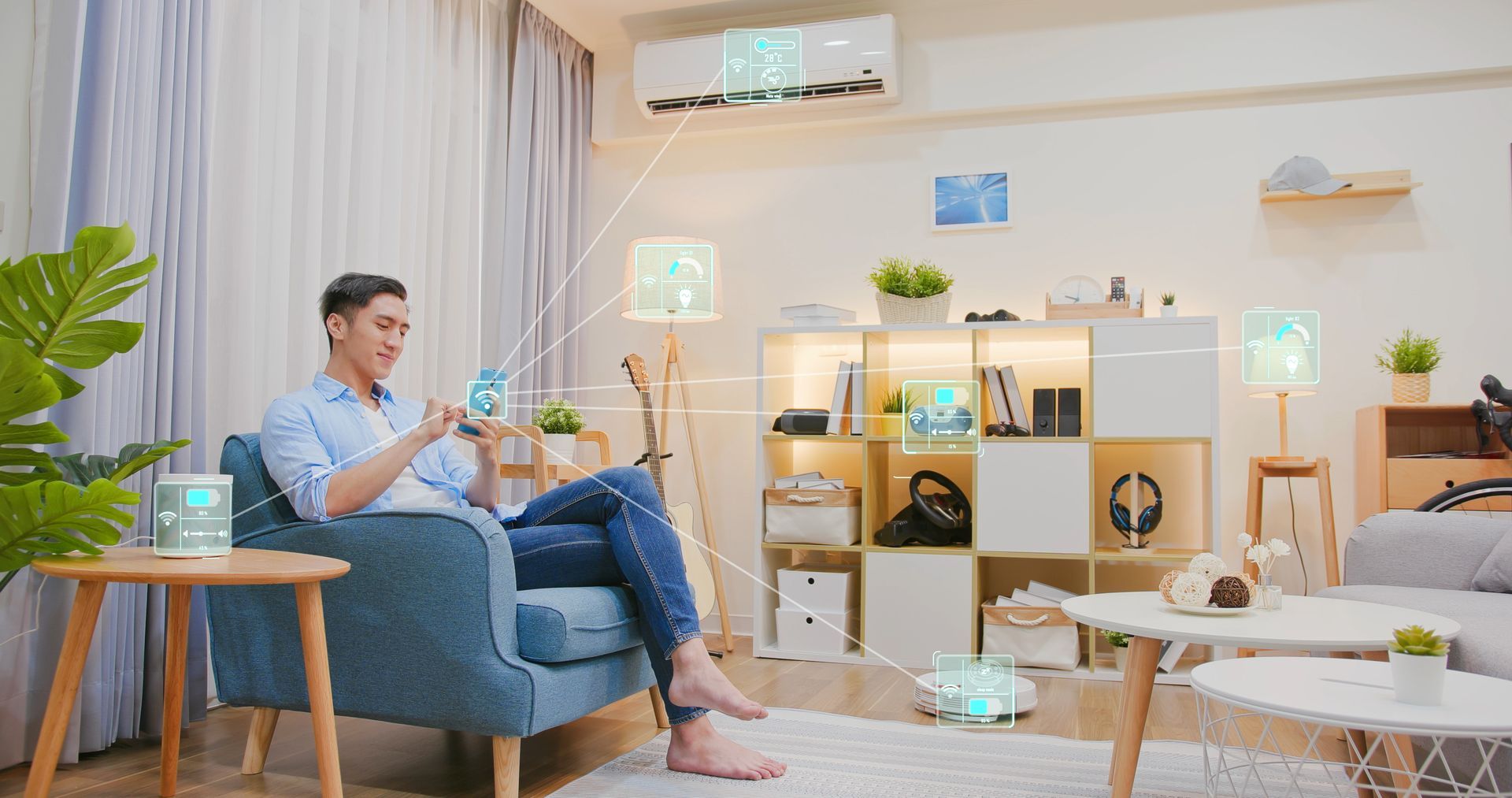 A man is sitting on a couch in a living room using a smart phone.