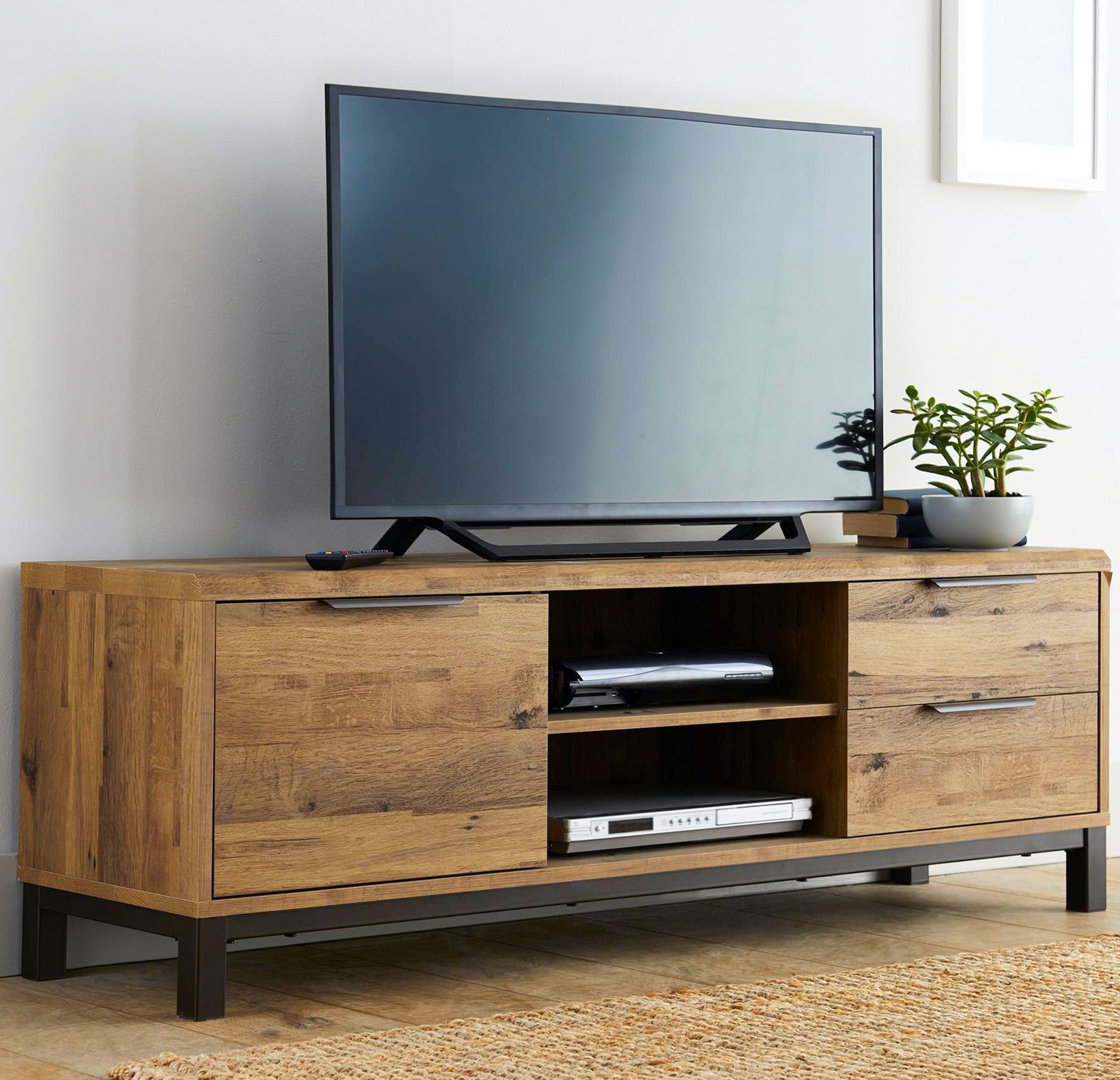 A flat screen tv is sitting on top of a wooden entertainment center
