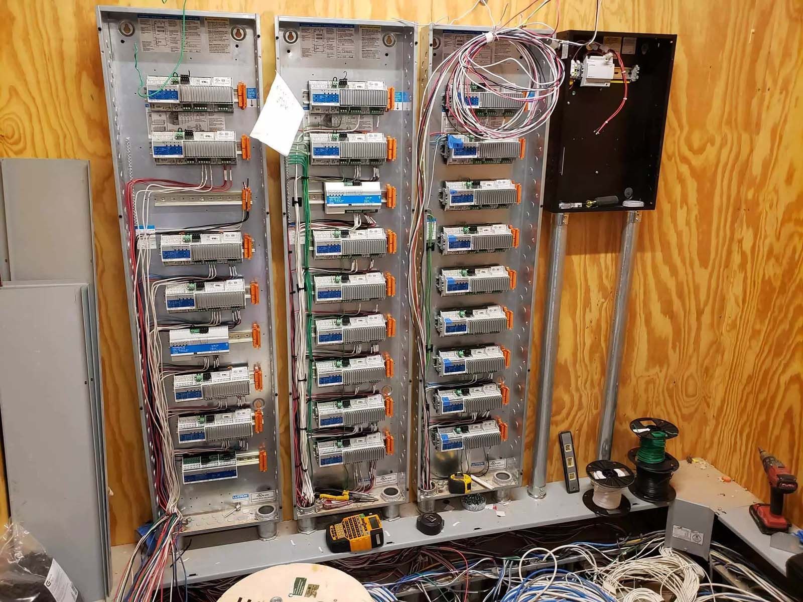 A bunch of electrical boxes are sitting on a table in a room.