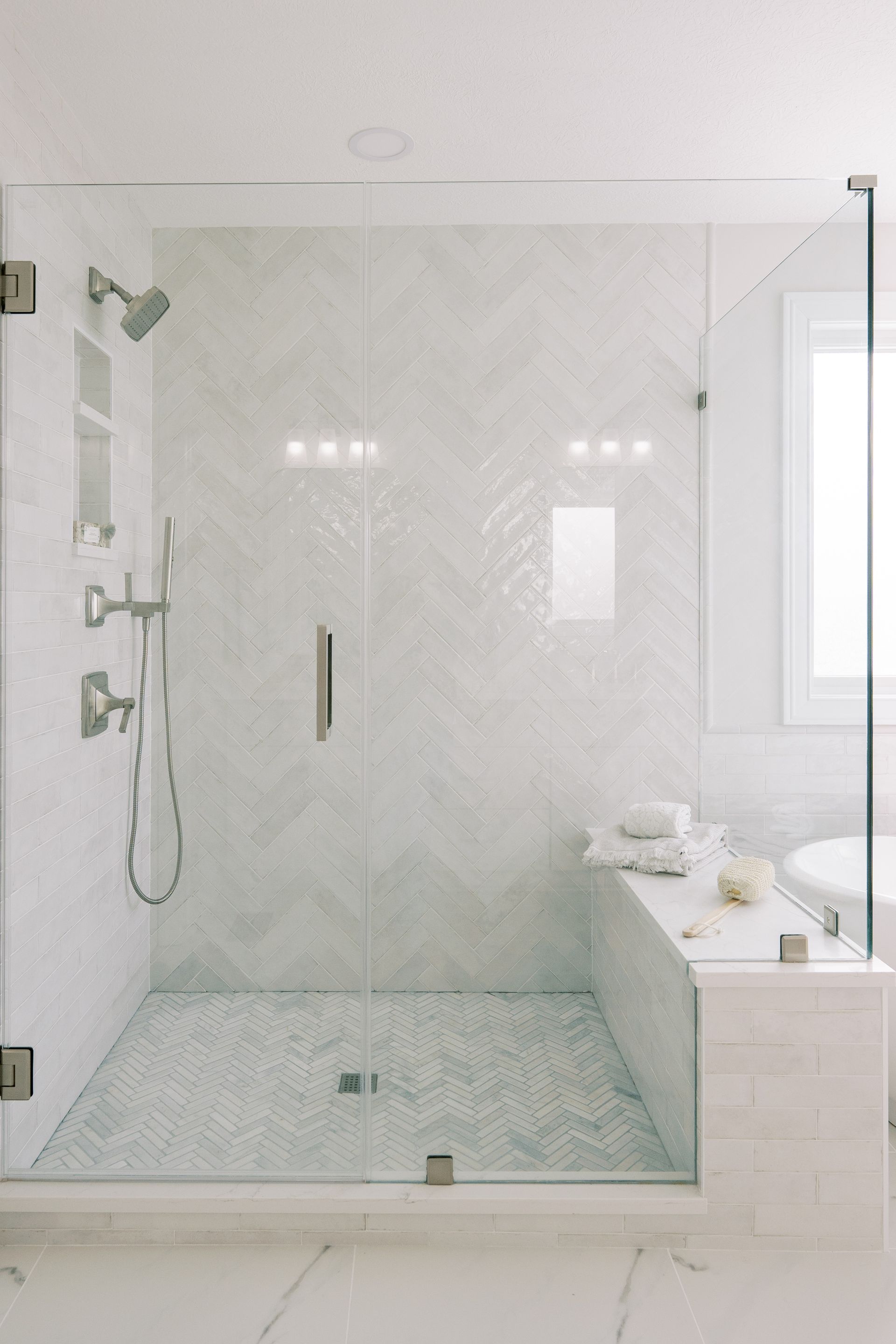 A bathroom with a walk in shower and a bathtub.