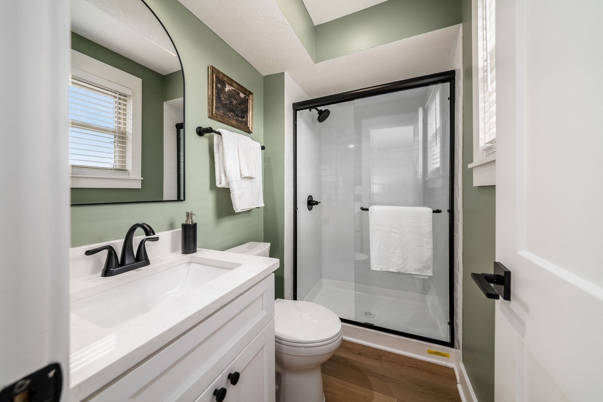 A bathroom with a walk in shower and a bathtub.