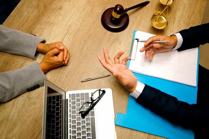 Men in a meeting and writing in a paper - Jacksonville, FL - Notary Ties LLC