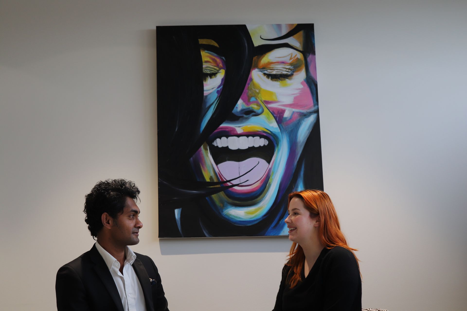 Dr Nara at RevAesthetic in Melbourne communicating effectively with patient looking into cosmetic surgery