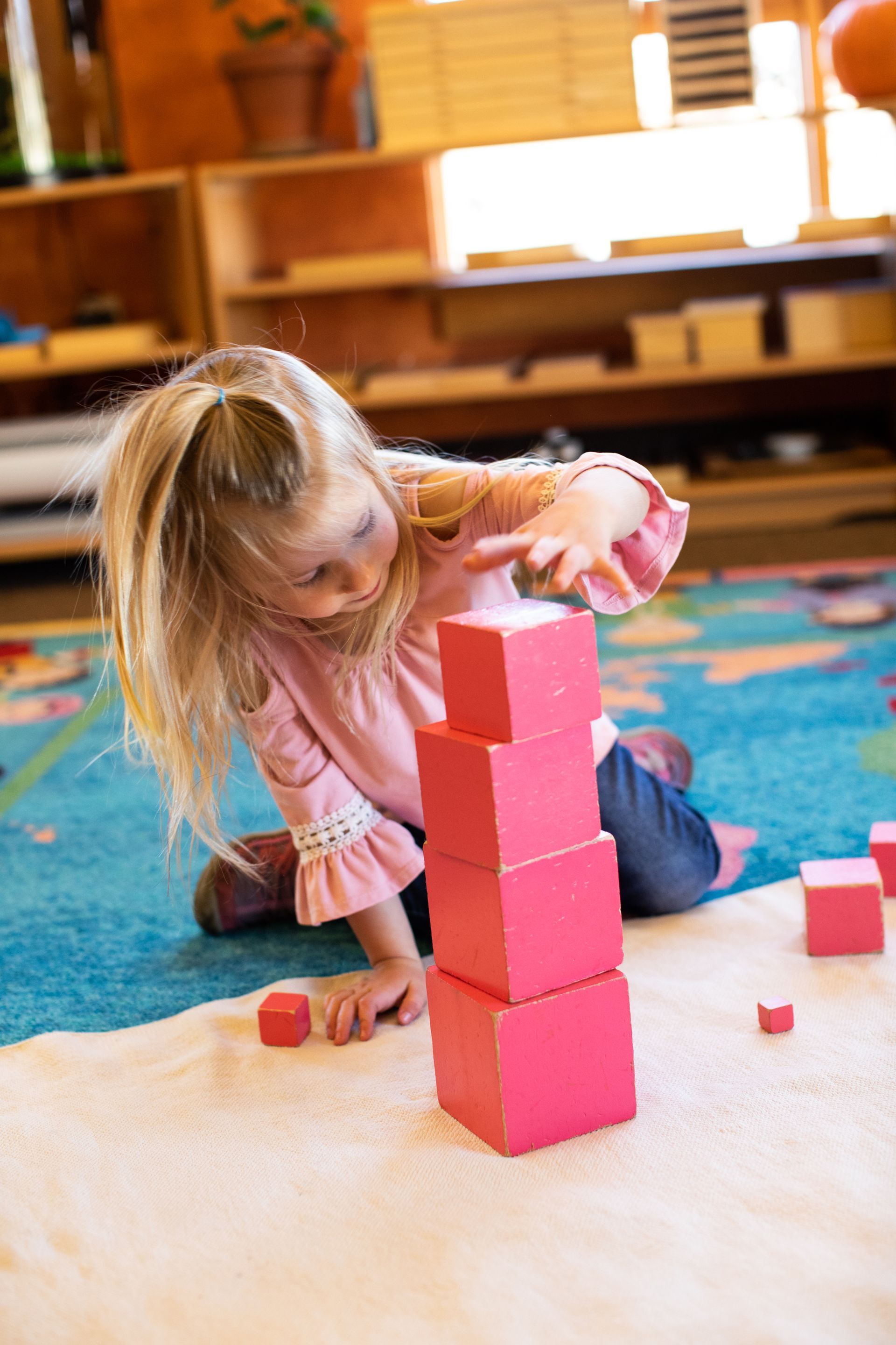 Children working with the Montessori pink tower