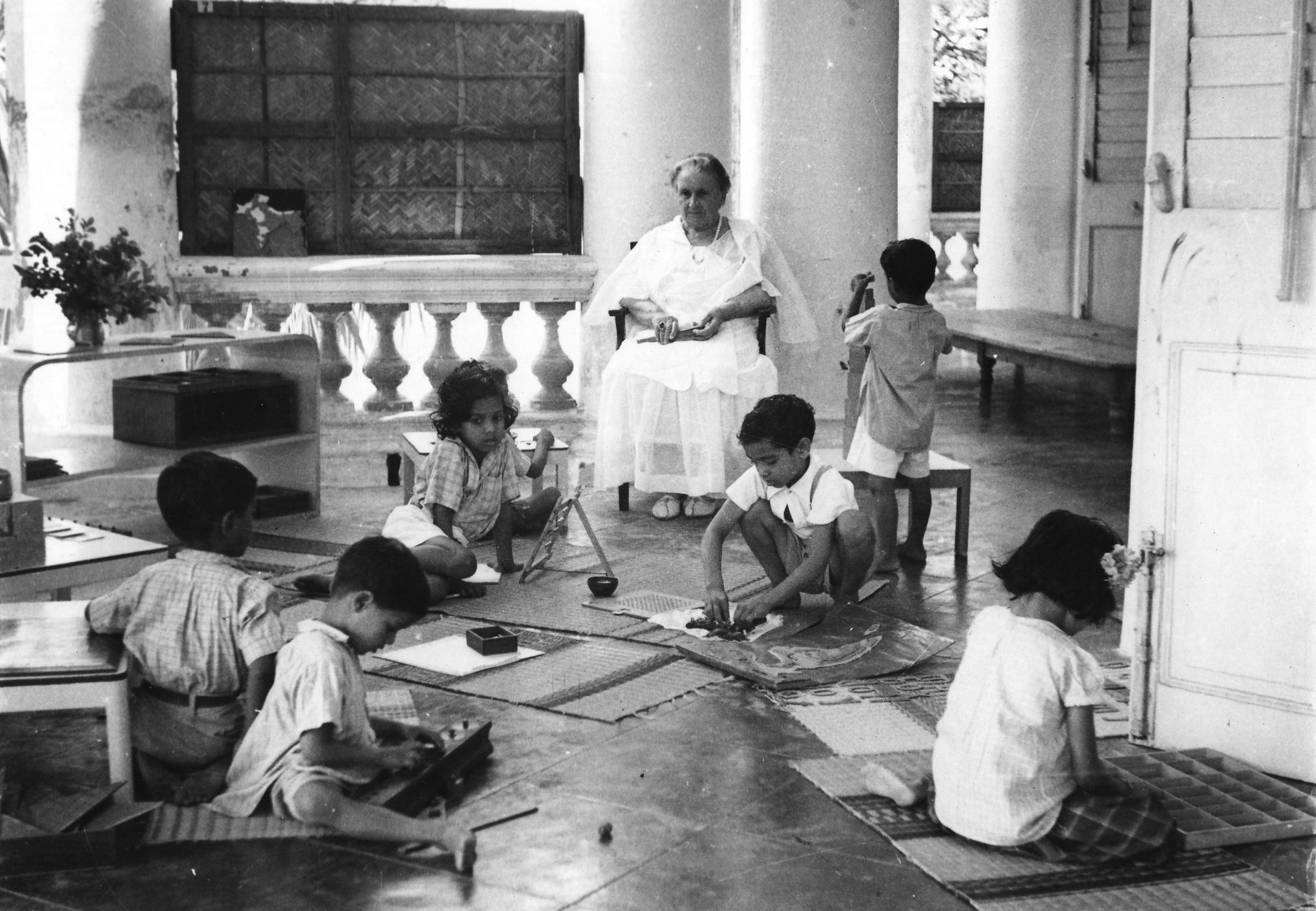 Dr Maria Montessori with a group of children in the classroom