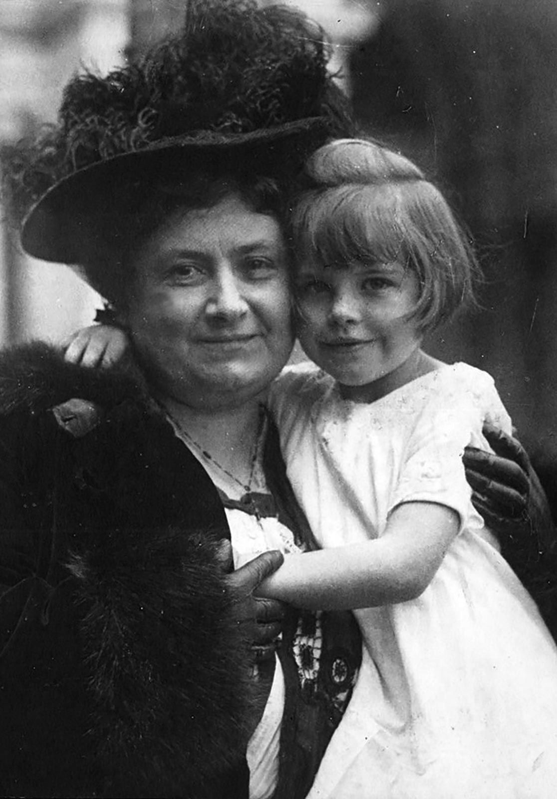 Maria Montessori holding a child