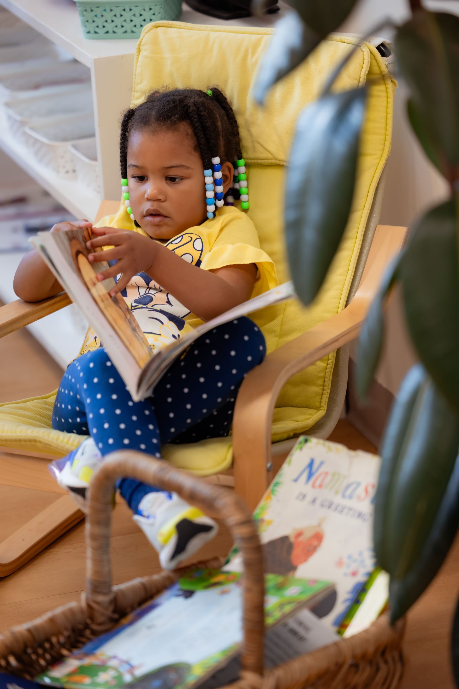 Montessori child reading a book.