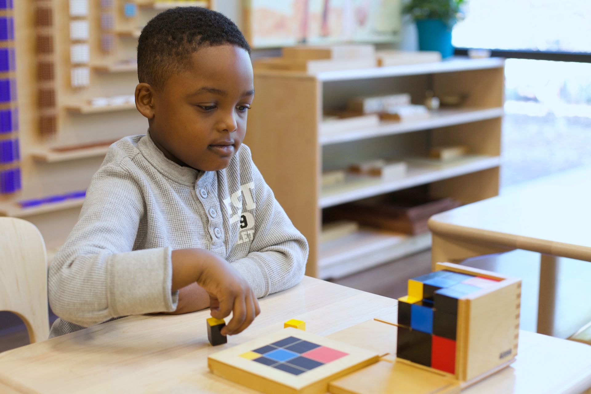 Montessori child working with math materials