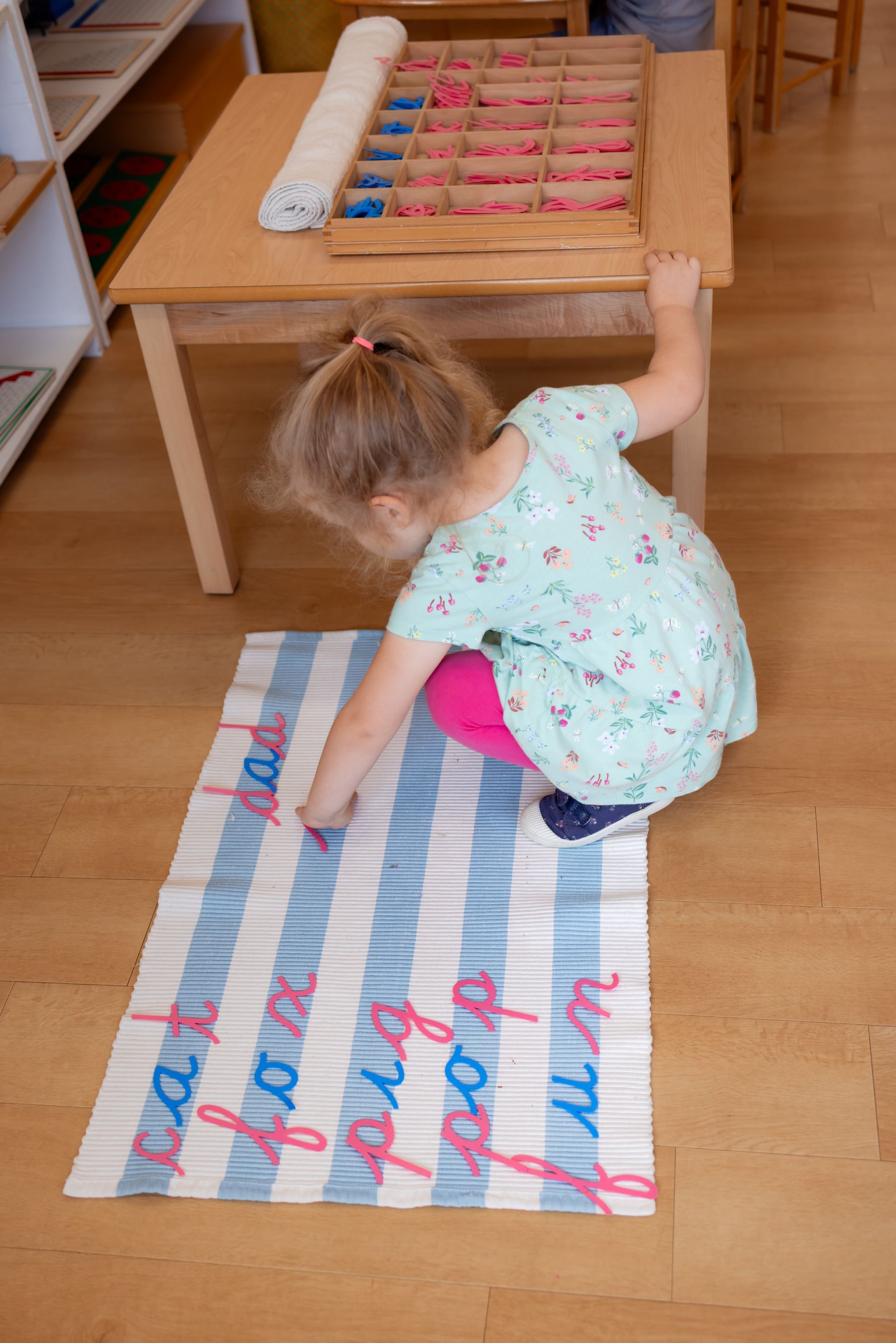 Montessori child working with language materials