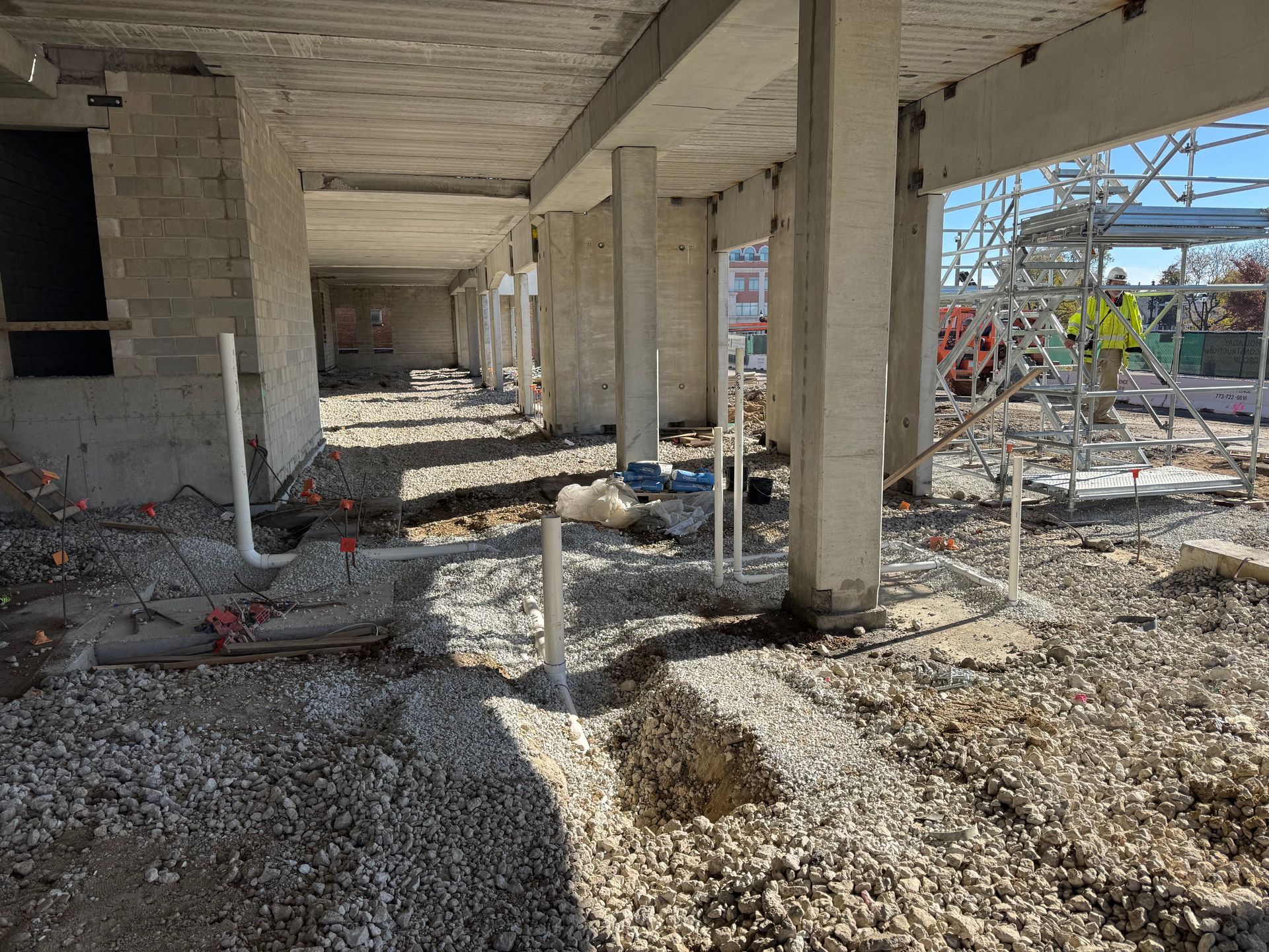Technician using testing equipment near a sink and gas boiler in a kitchen