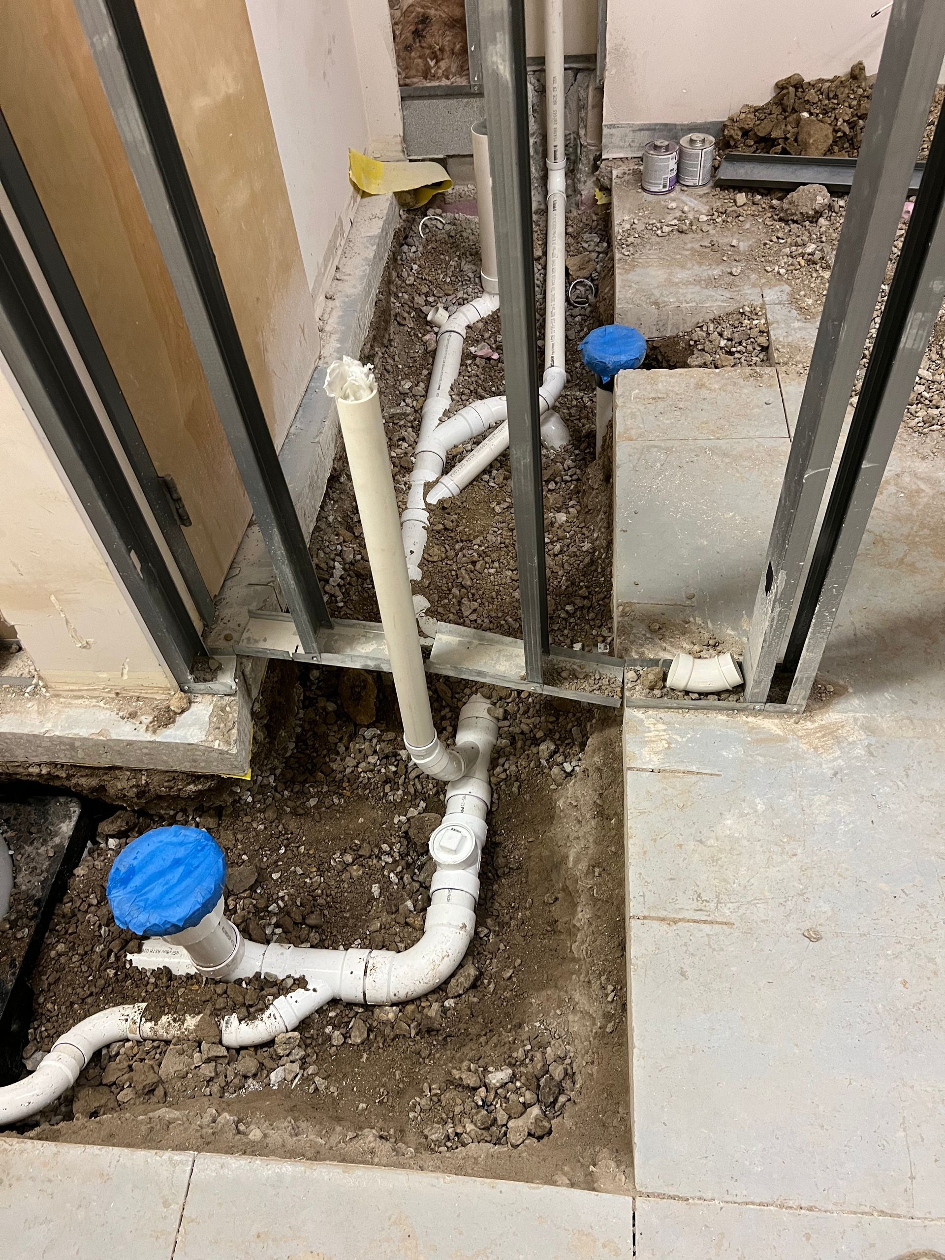 Person in blue uniform inspecting a heating appliance door