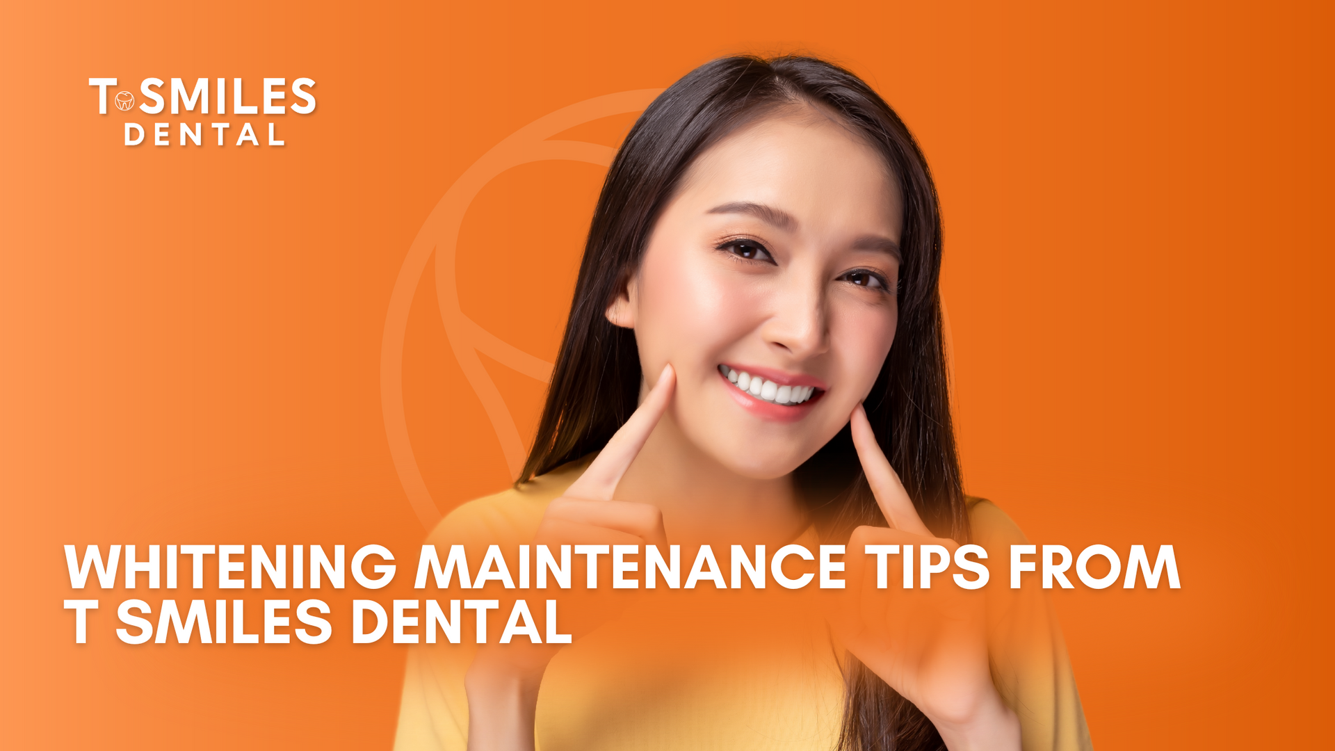 A woman is smiling with her hands on her face.