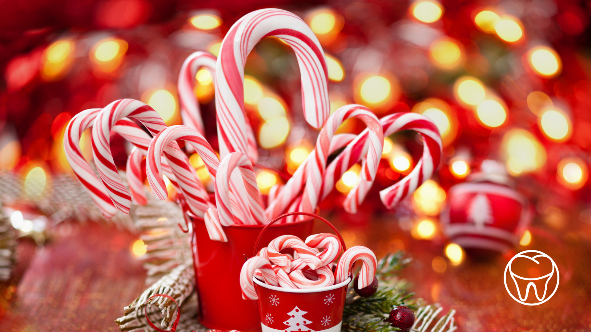 A cup of hot chocolate with candy canes in it.