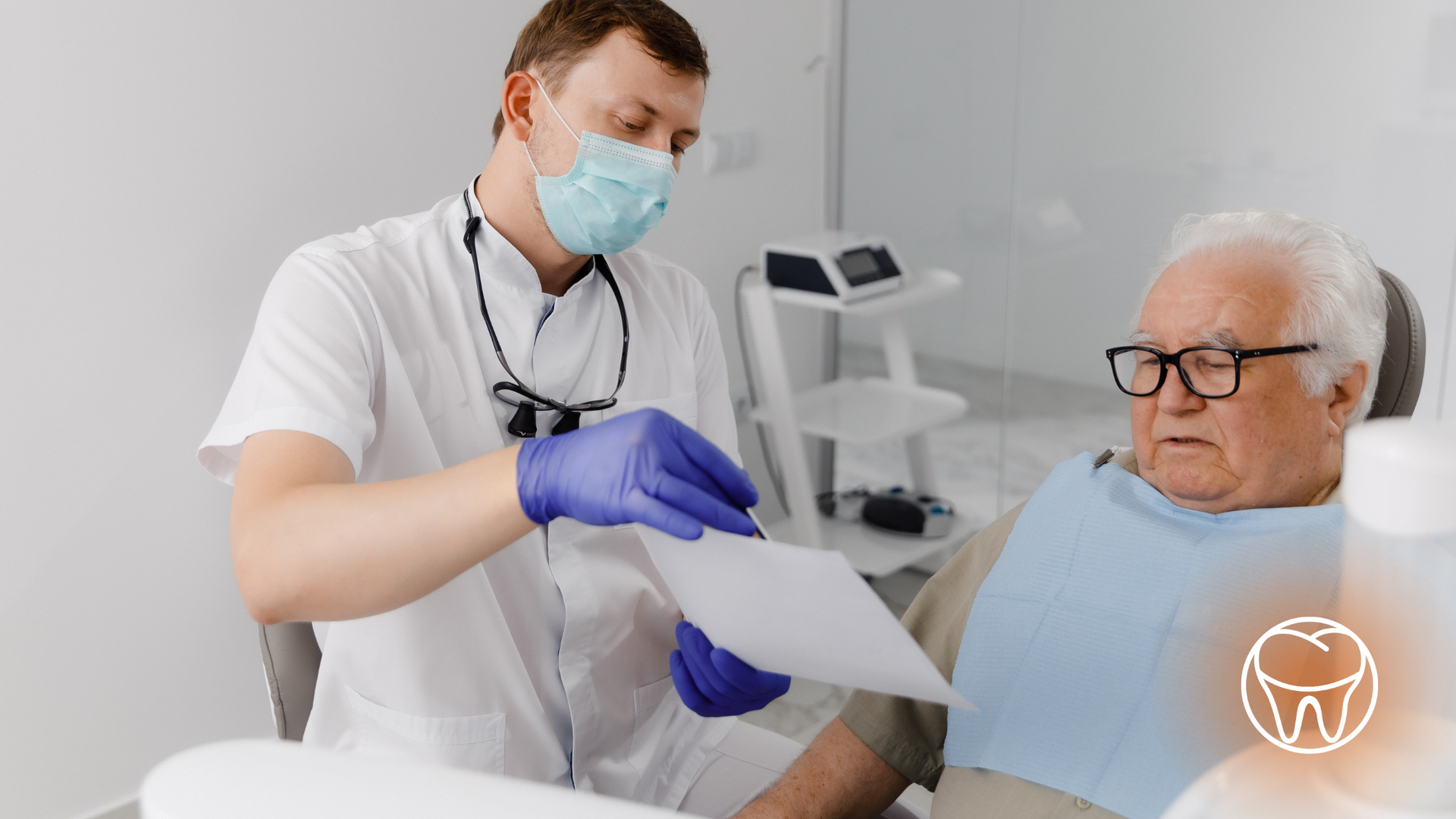 A dentist is talking to an elderly man in a dental chair.