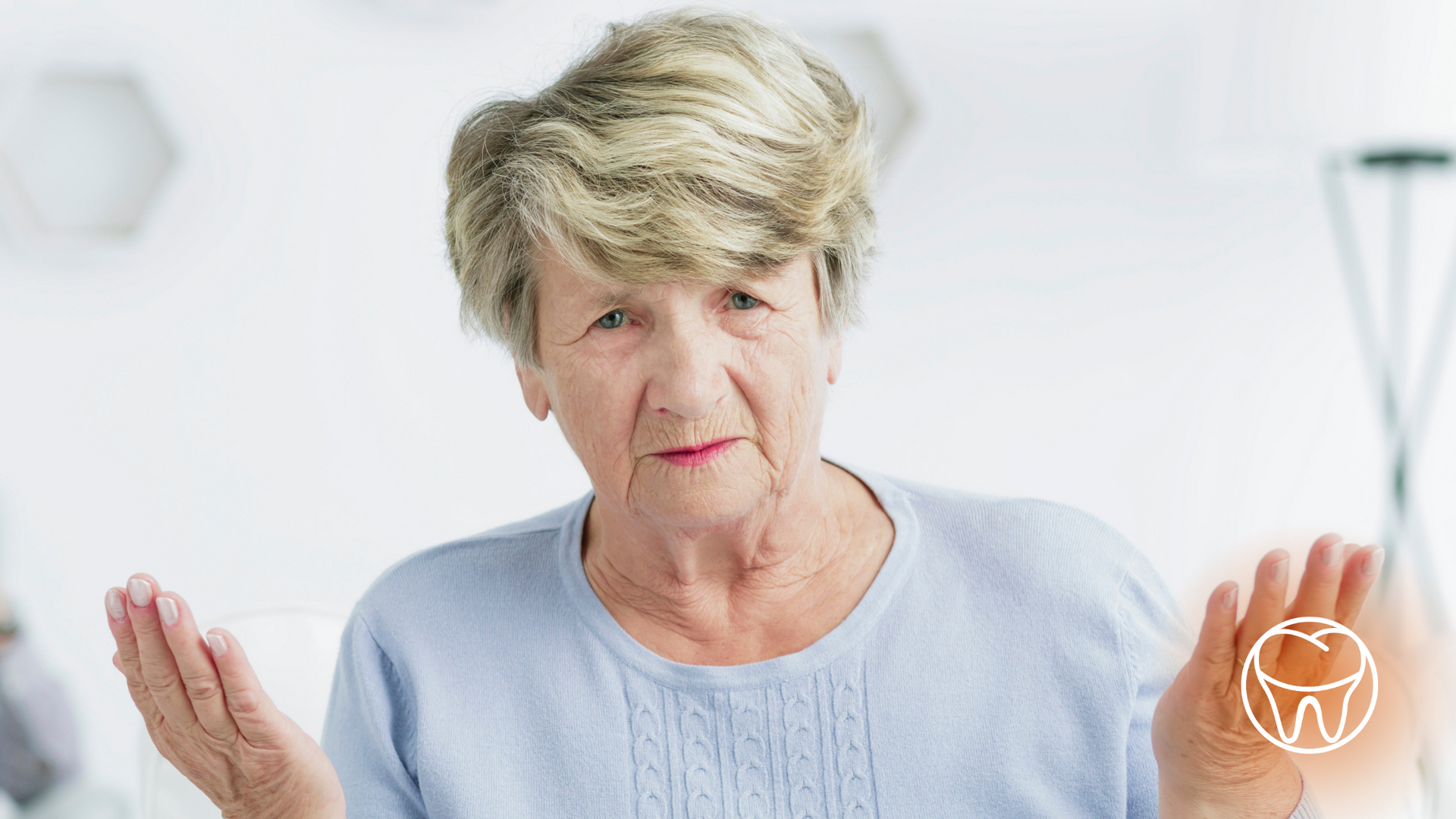 An elderly woman is holding her hands up in the air.