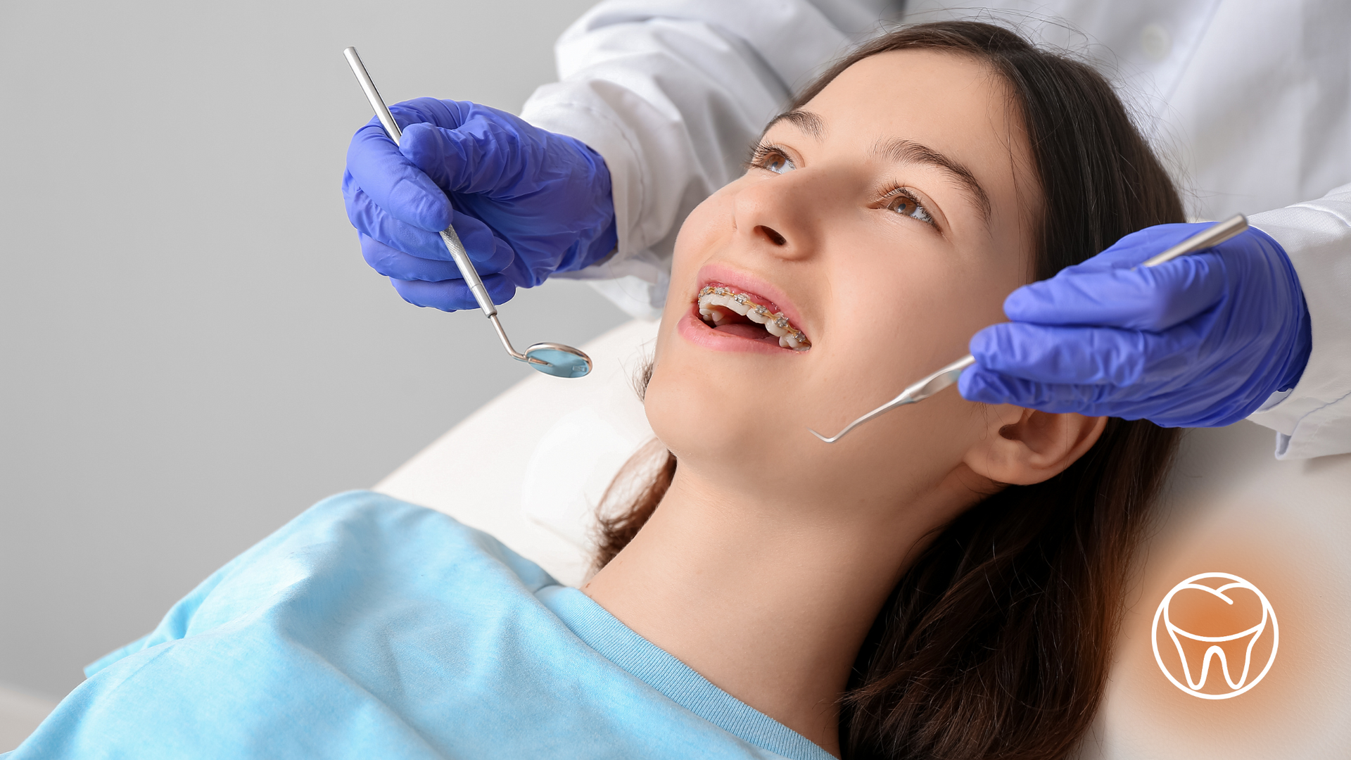 A woman is getting her teeth examined by a dentist.