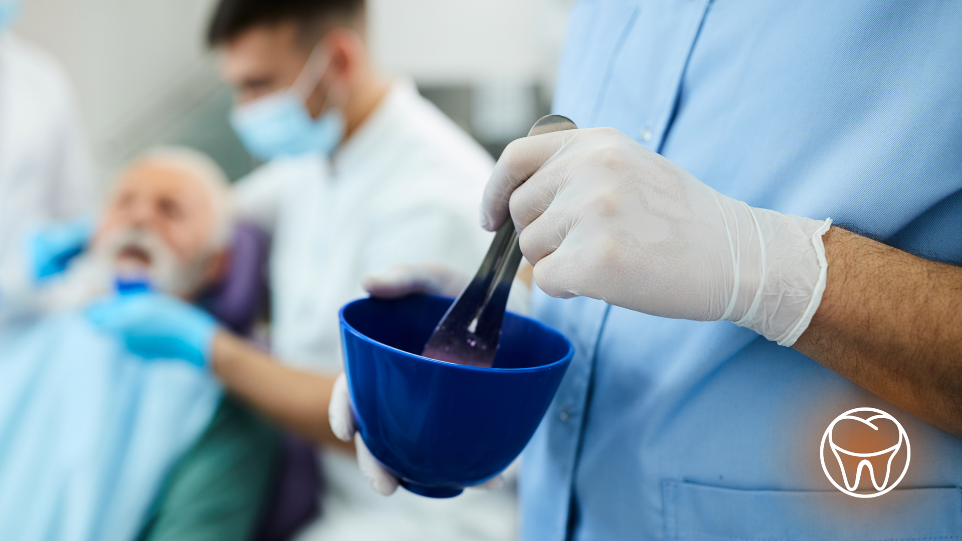 A dentist is mixing something in a blue bowl with a spoon.