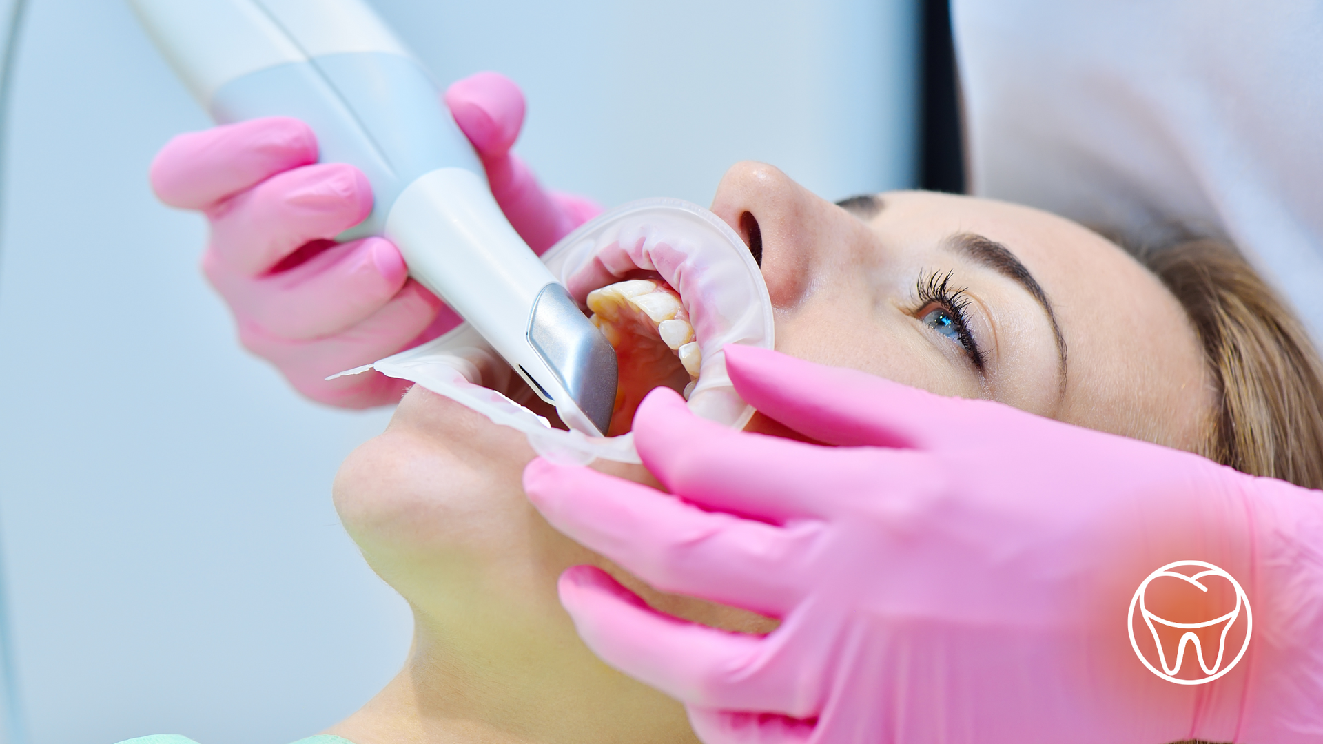 A woman is getting her teeth examined by a dentist.