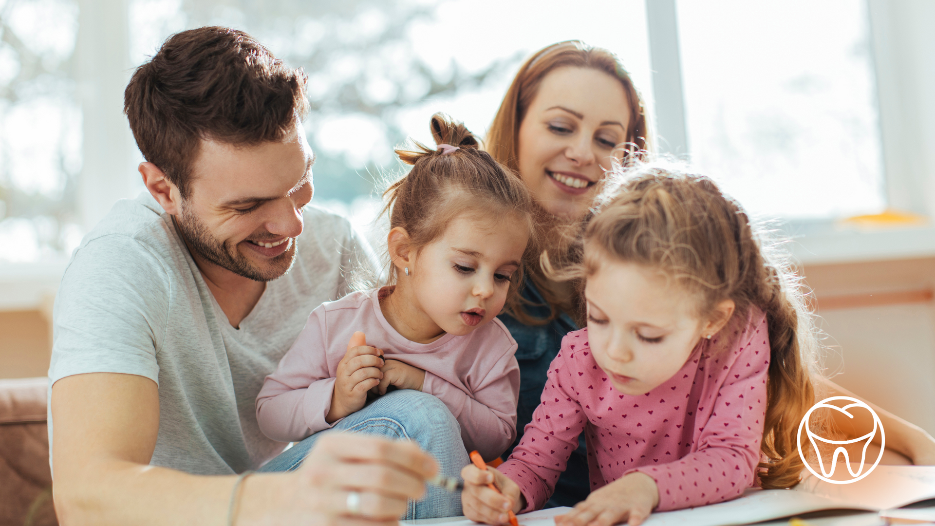 Family of four coloring together at home.
