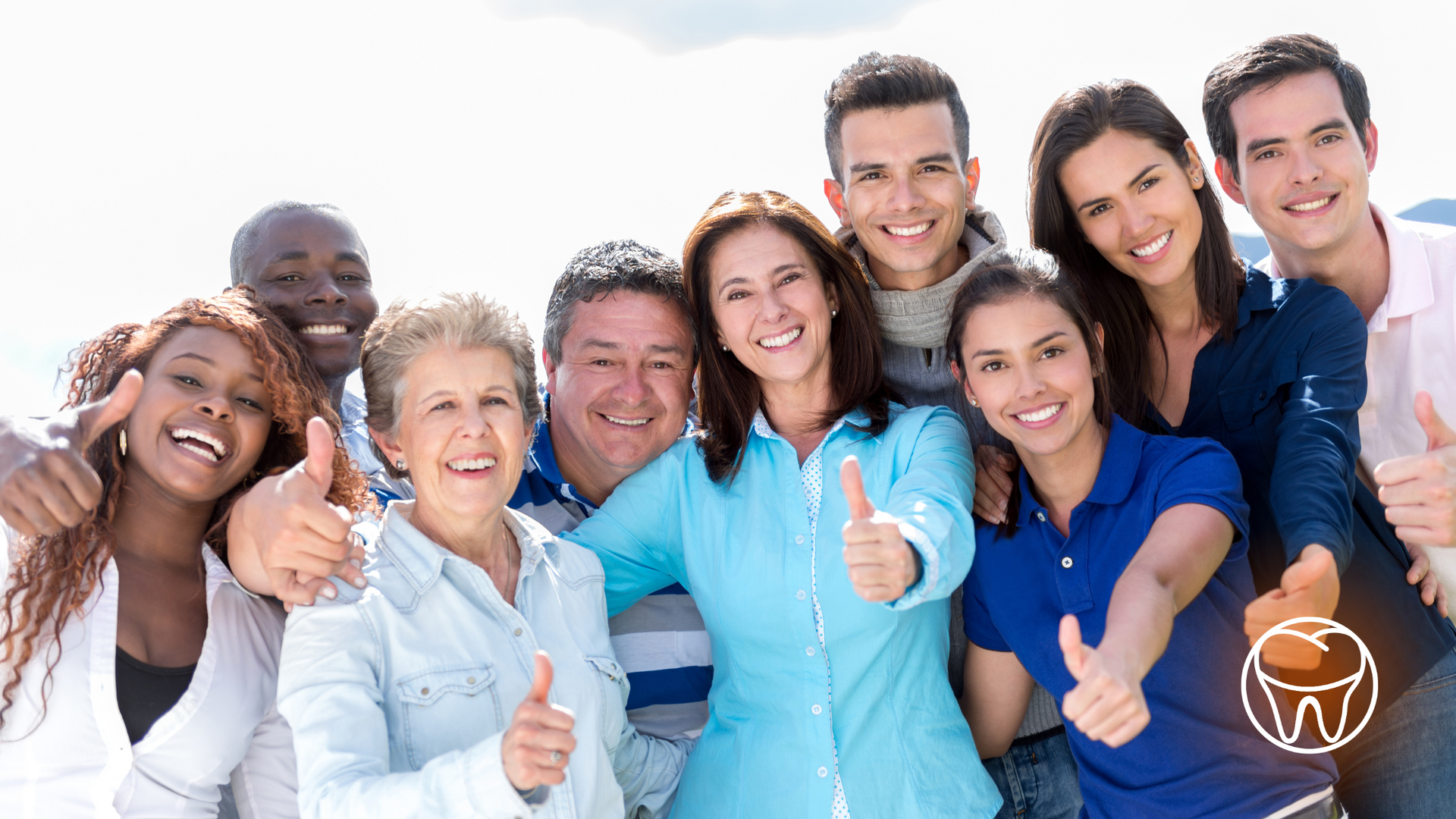 A group of people are posing for a picture and giving a thumbs up.